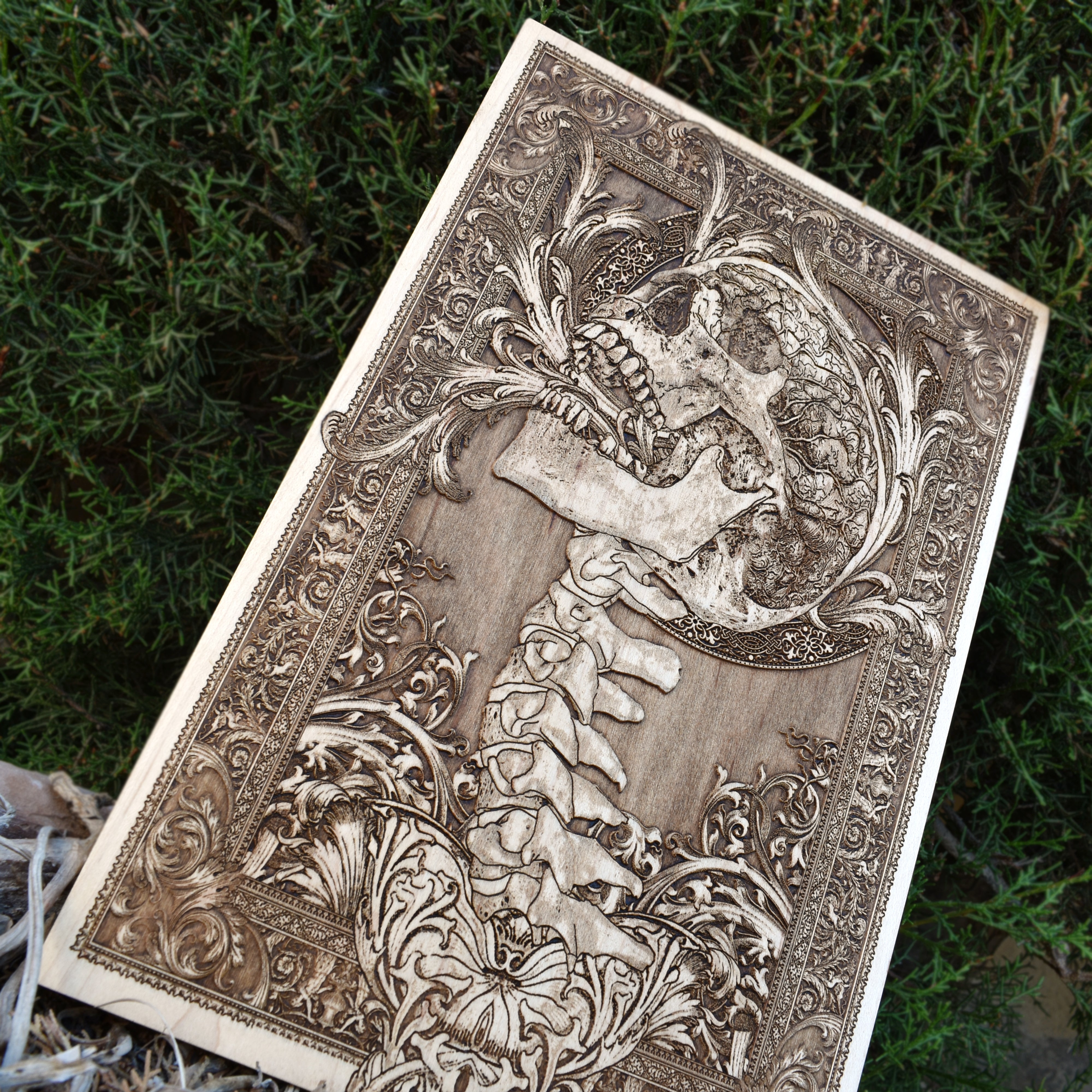 Handcrafted wooden art featuring a terrifying screaming skull and spine, ideal for gothic decor.