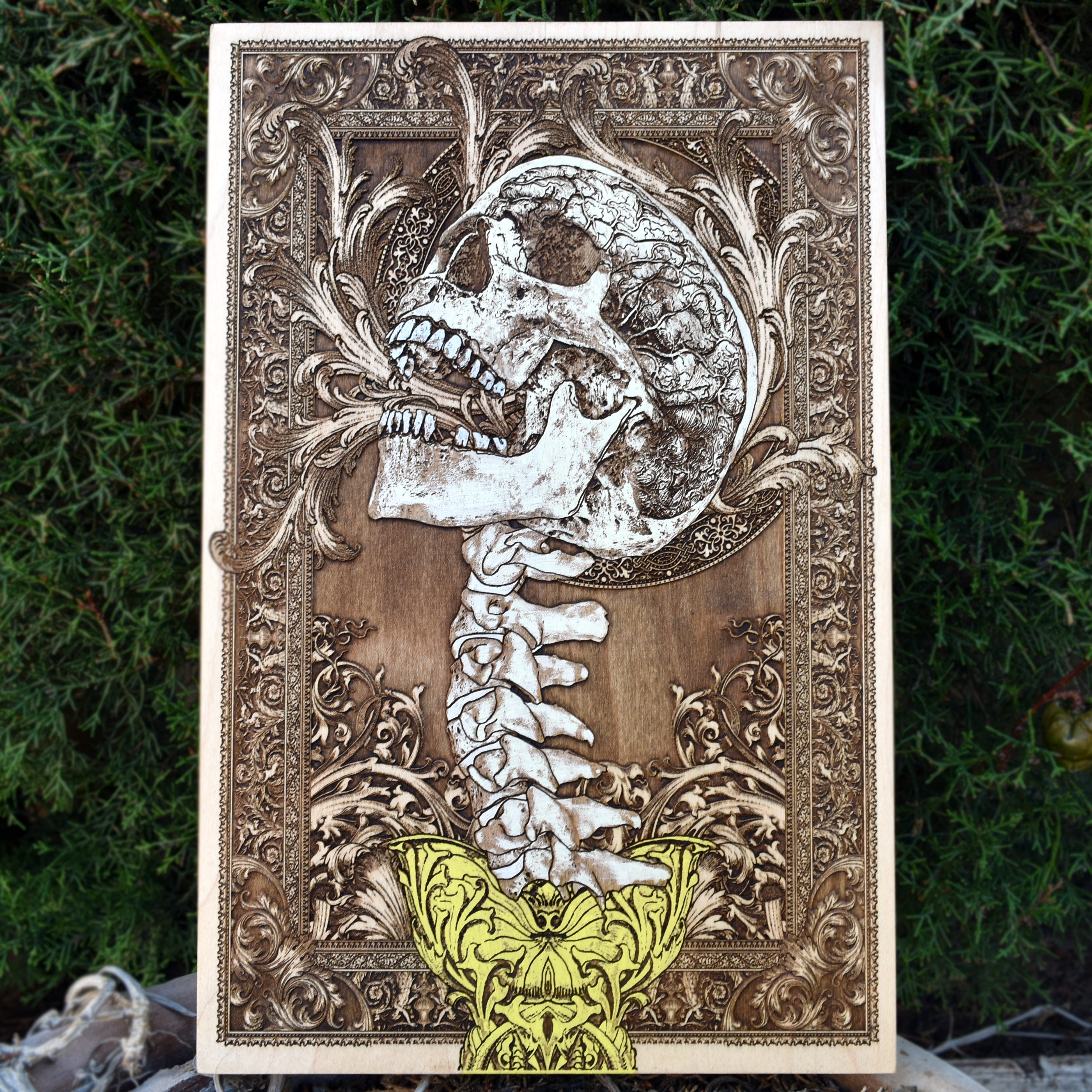 Engraved screaming skull and spine wood art, perfect for gothic horror home decor.