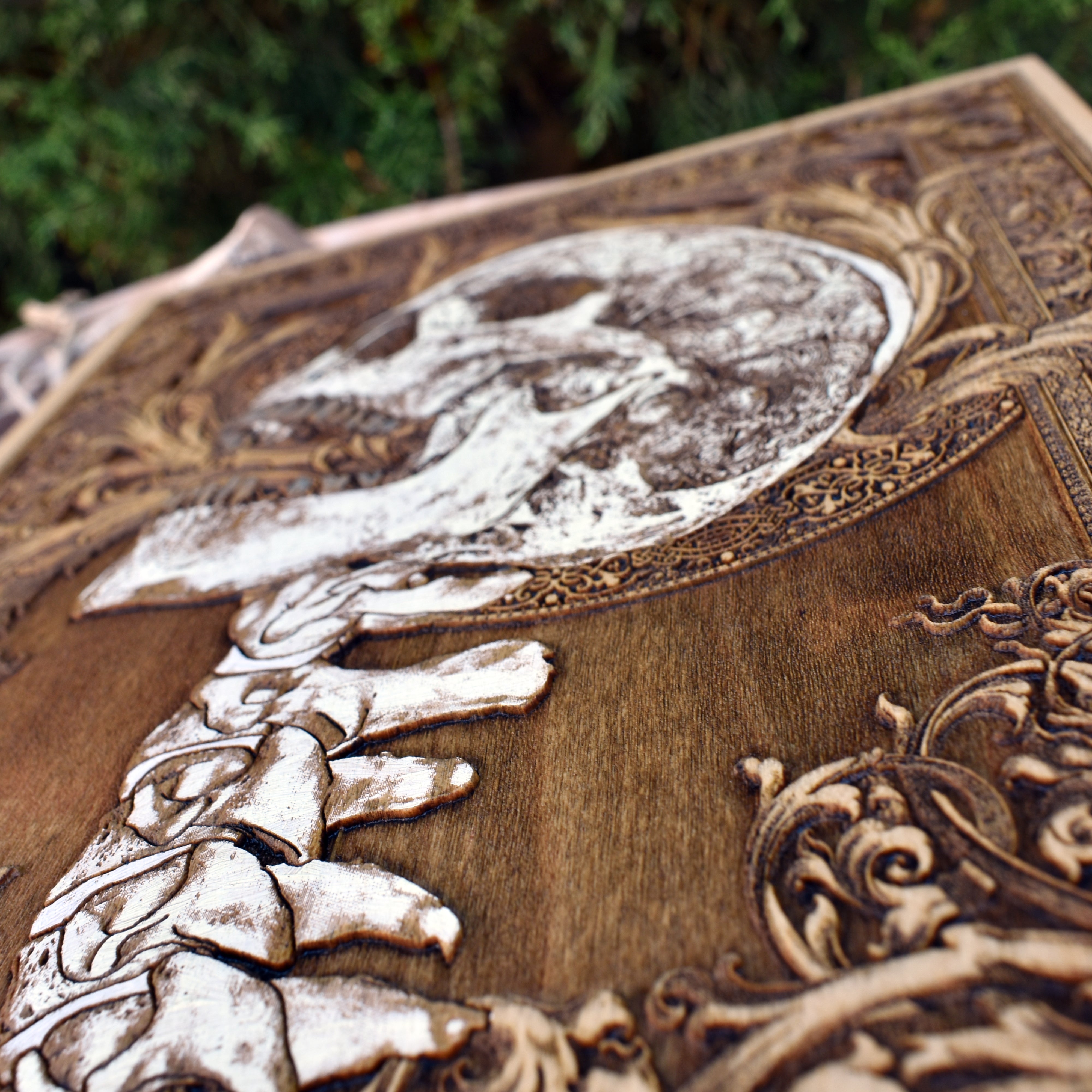 Detailed laser-engraved skull and spine on wood, great for Halloween interiors.