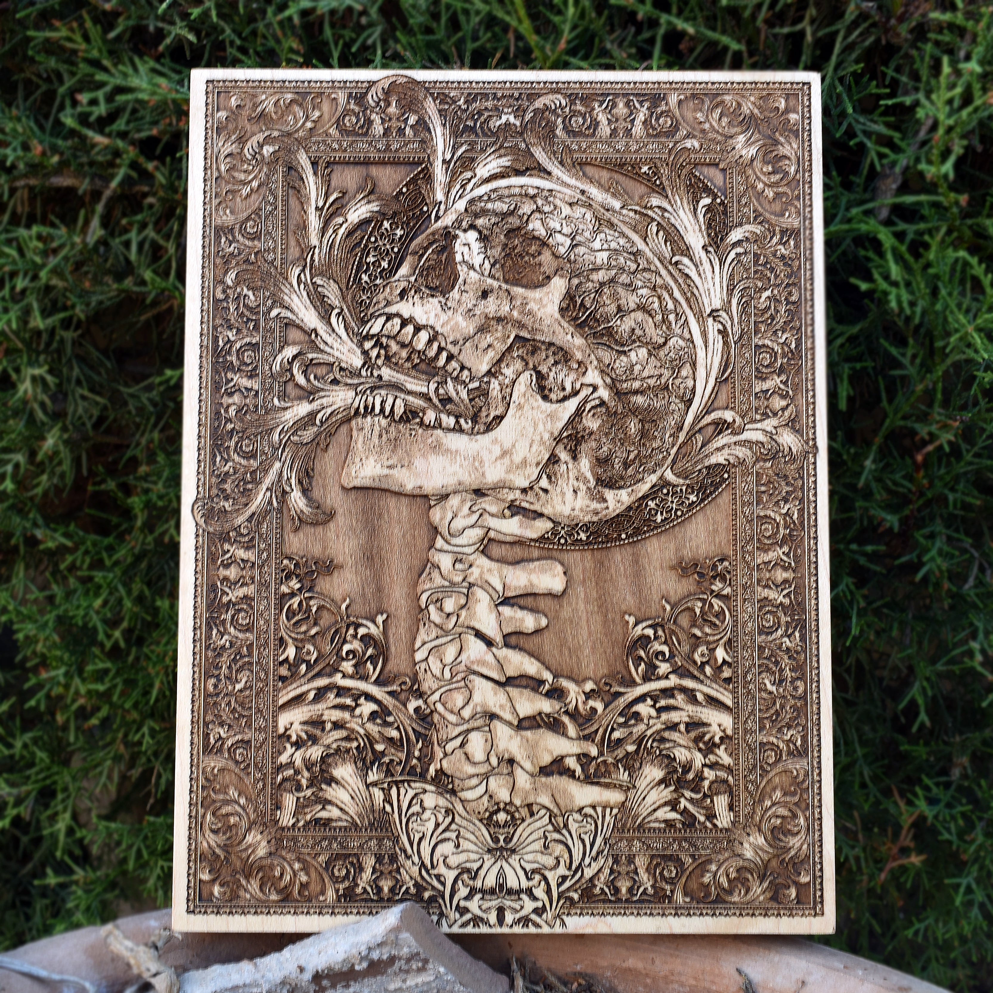 Engraved gothic skull wood artwork with human spine design, perfect for horror decor, 5-year wood anniversary, and skull lovers.