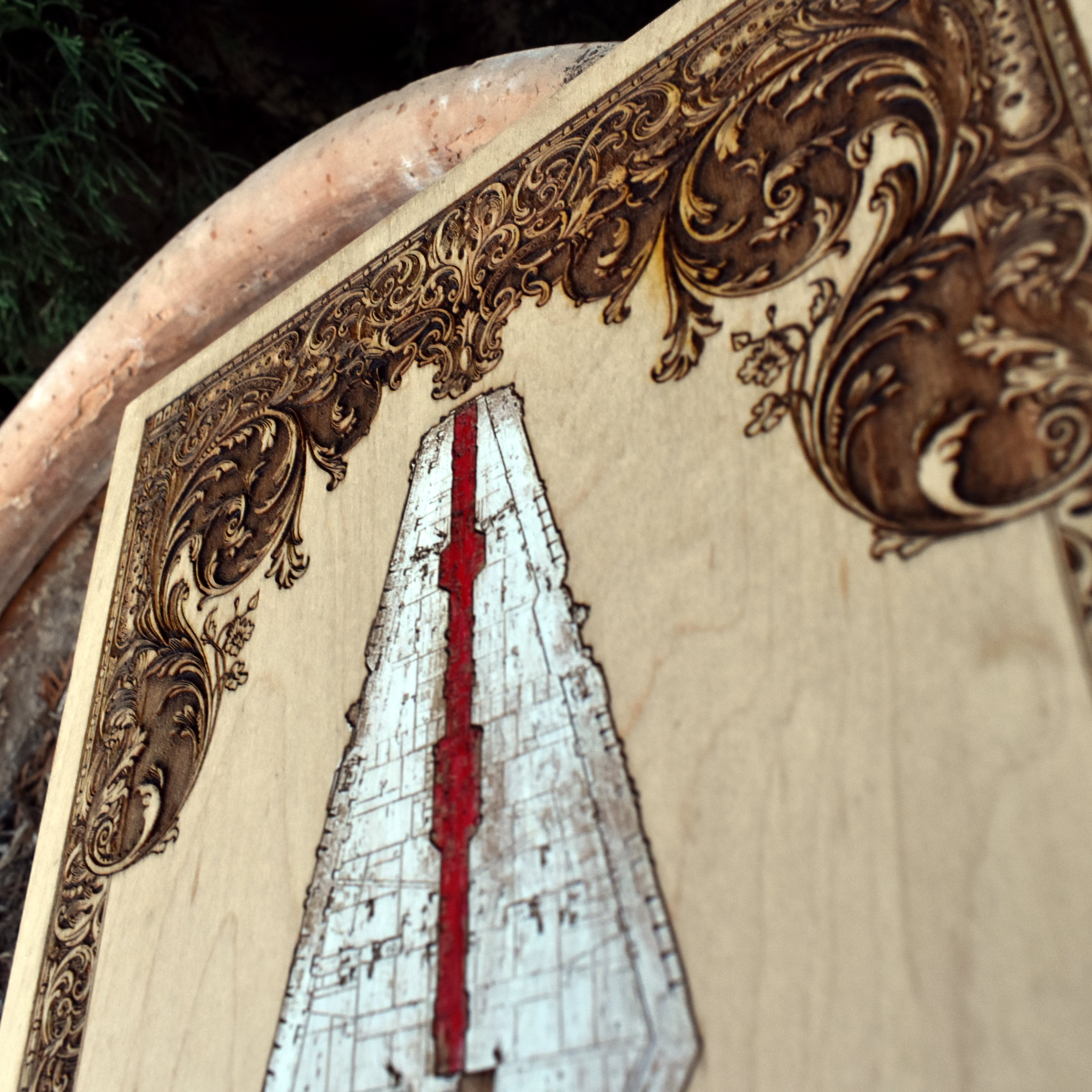 Custom wood art featuring iconic Star Wars-inspired star cruiser engraving.