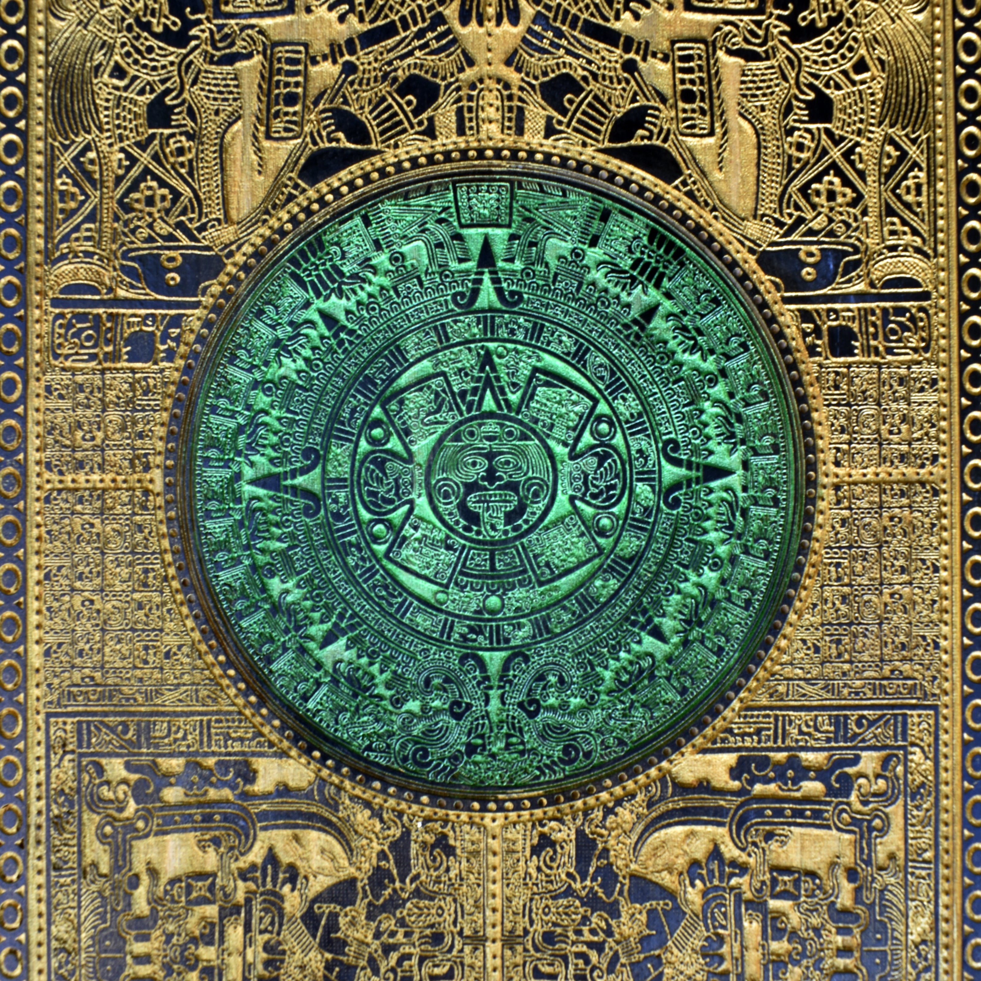 Gold-accented Aztec sun stone on dark wood, perfect gift for history lovers.