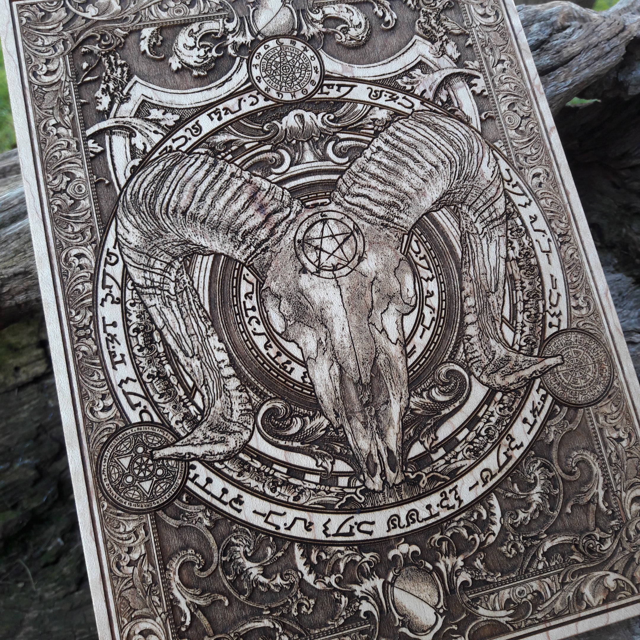 Macabre horned ram skull wood wall art with an intricately detailed occult design.