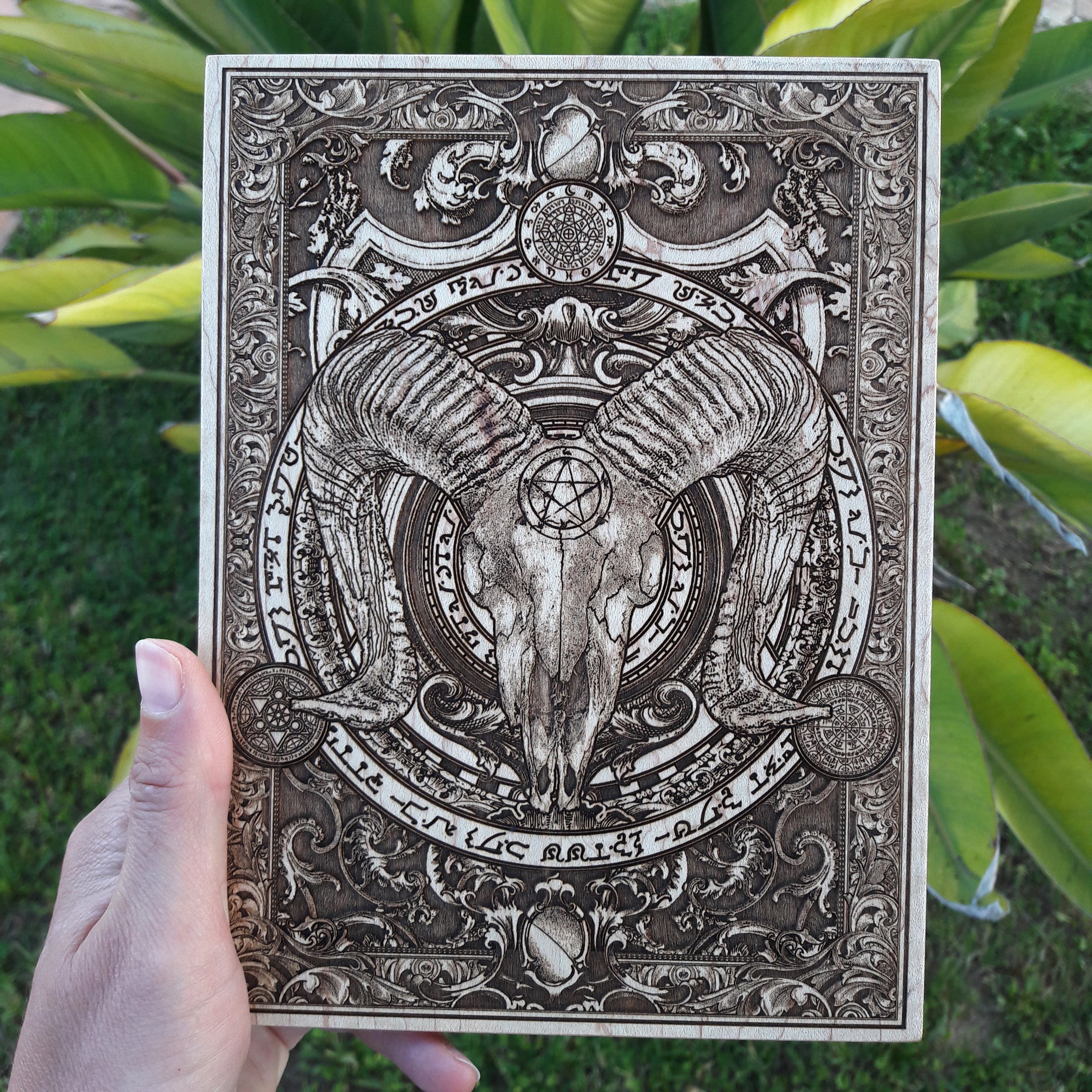 Mysterious and dark Baphomet-inspired wood engraving of a horned ram skull.
