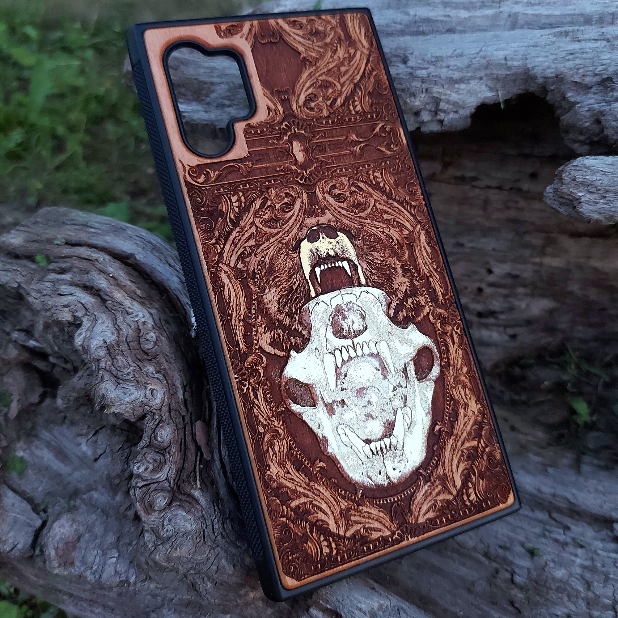 Laser-engraved bear skull design on a wooden phone case, featuring intricate gothic artwork, compatible with iPhone 16, iPhone 15, Galaxy S25, and more.