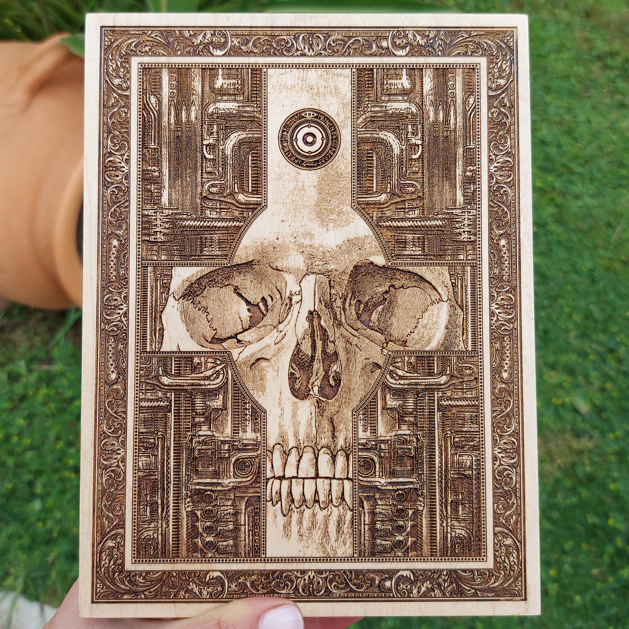 Handcrafted gothic skull cross wood wall art with biomechanical design.