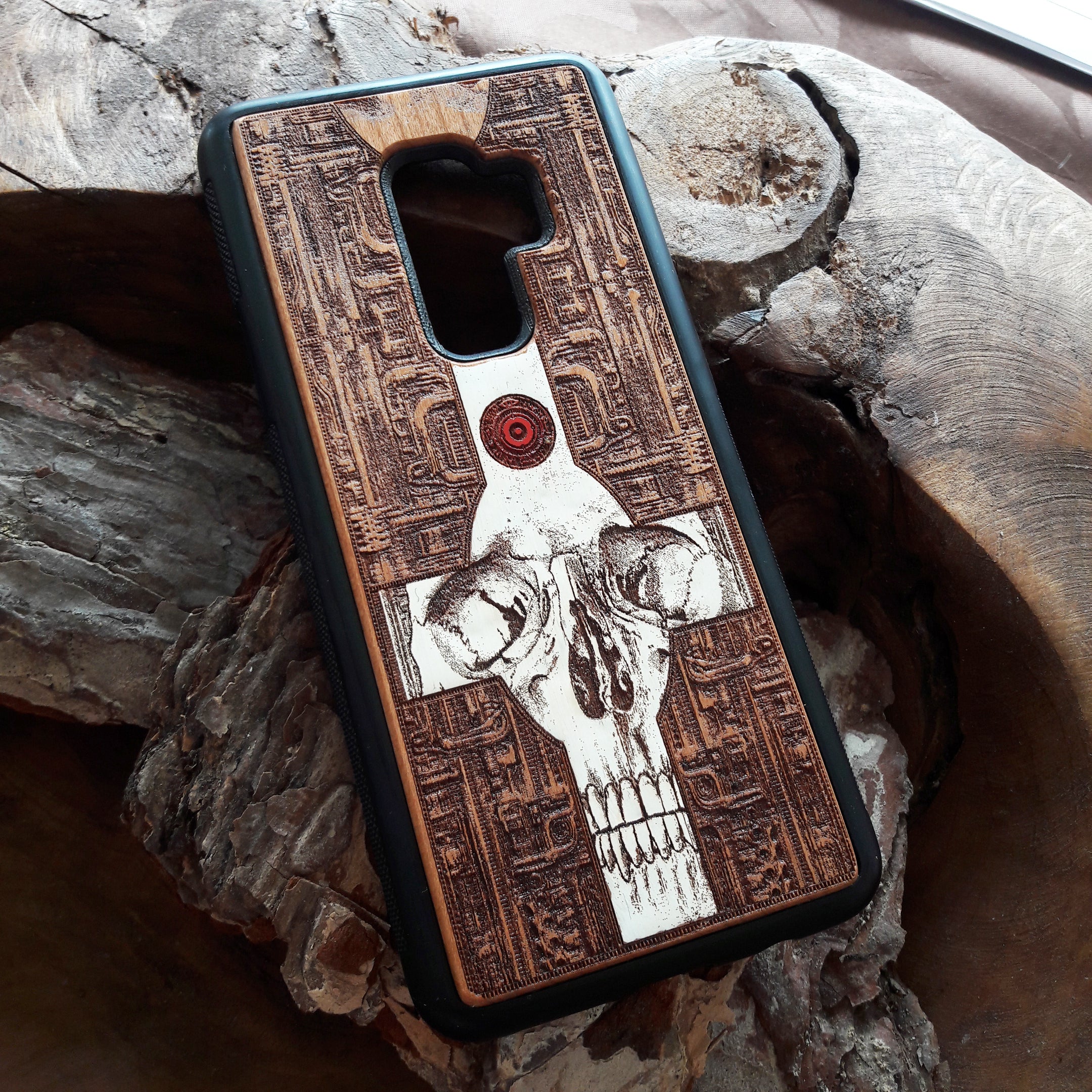 Laser-engraved wooden phone case featuring a gothic skull and cross design, compatible with iPhone 16, iPhone 15, Galaxy S25, and more