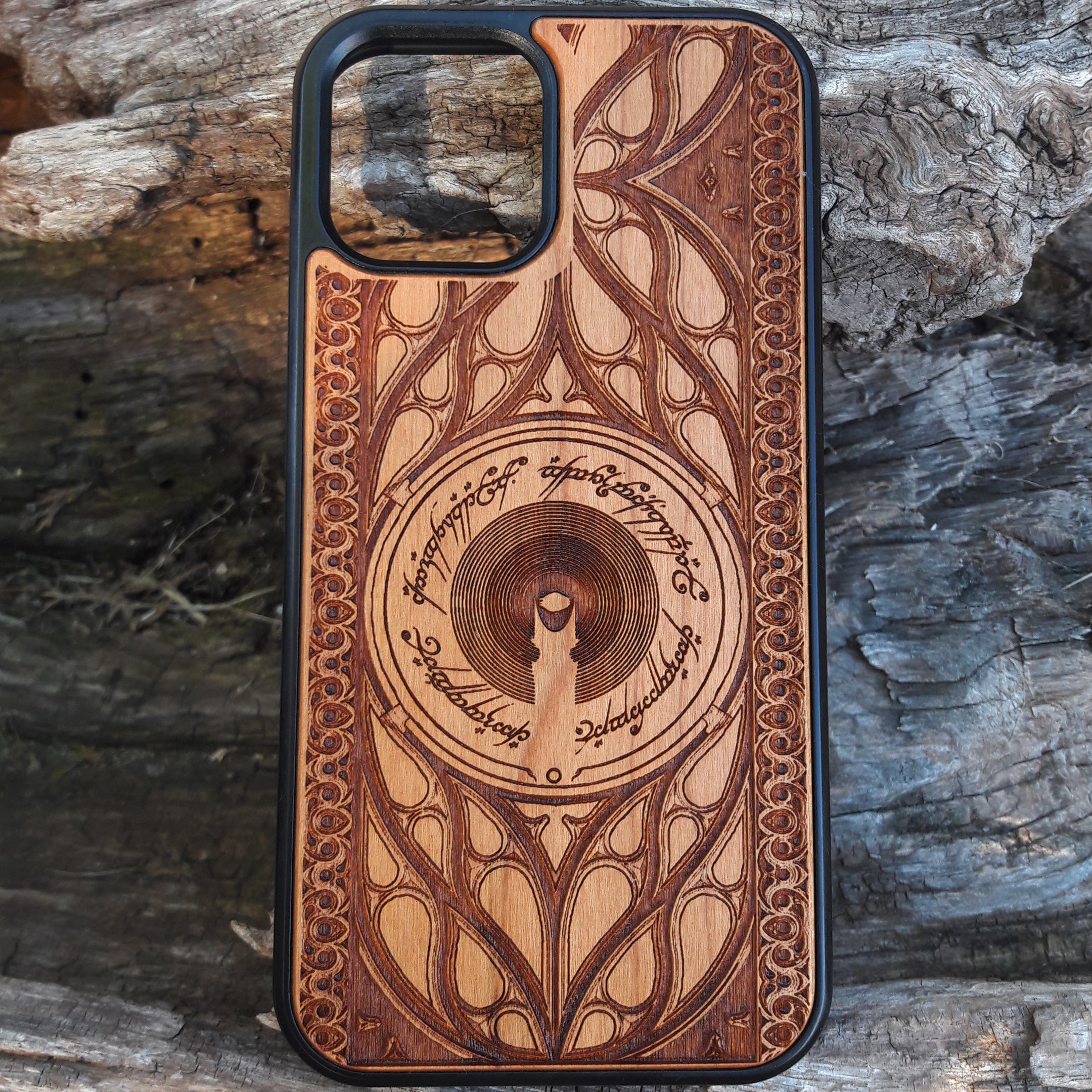 Wooden phone case featuring a Gothic Lord of the Rings-inspired design, with intricate laser-engraved patterns. The design includes dark, medieval-style elements with Elvish script, capturing the essence of Middle-Earth's dark aesthetic. Compatible with iPhone , 15, 14, 13, 12, 11 Pro Max Mini, and Samsung Galaxy S, S24, S23, S22, S21, S20 Ultra, Plus, and Note 20. A unique and protective accessory for Tolkien fans with a taste for Gothic style.
