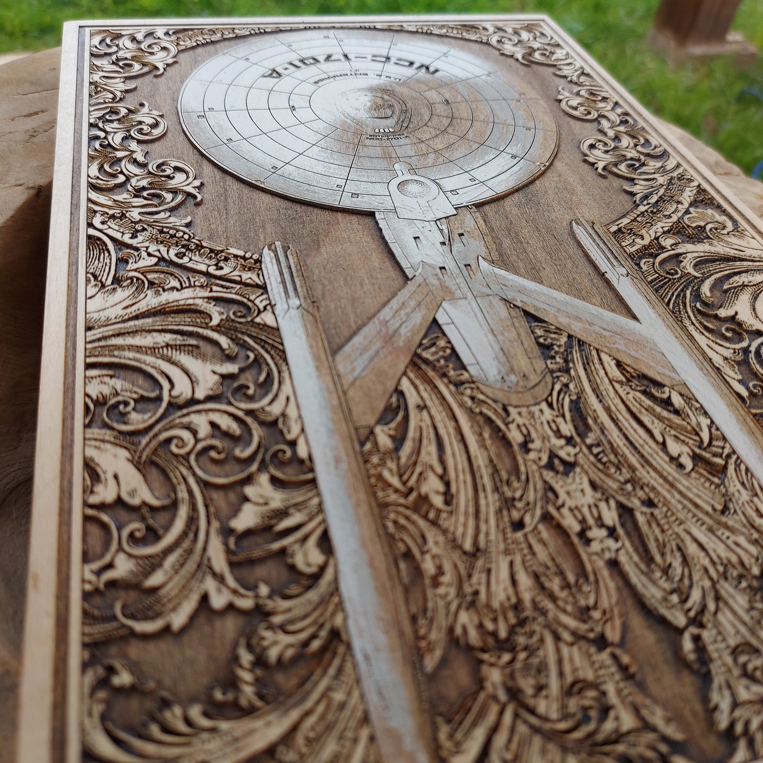 Sci-fi anatomical spaceship design on wood, inspired by Enterprise NCC-1701A.