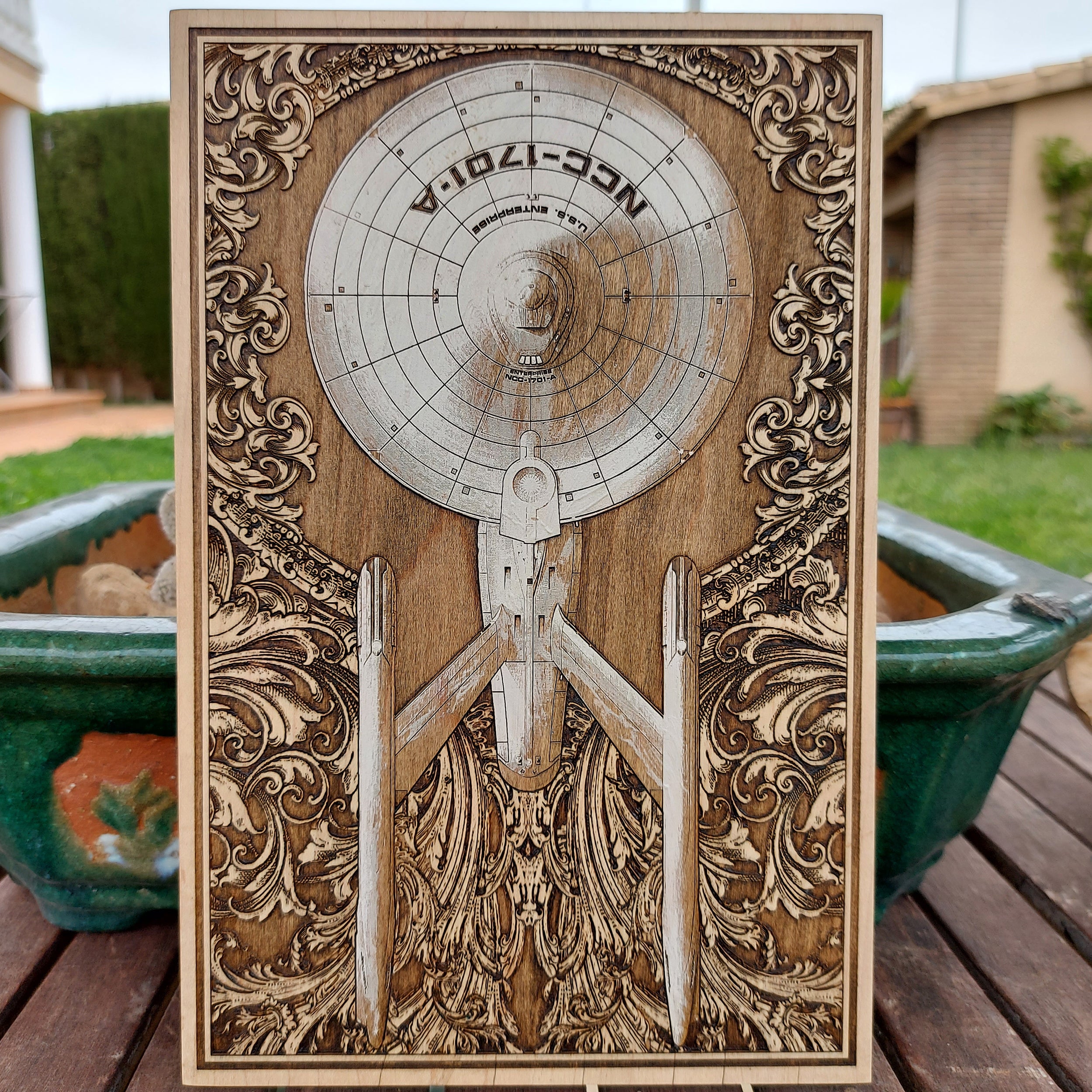Hand-painted wood artwork of Enterprise NCC-1701A with labeled spaceship anatomy.