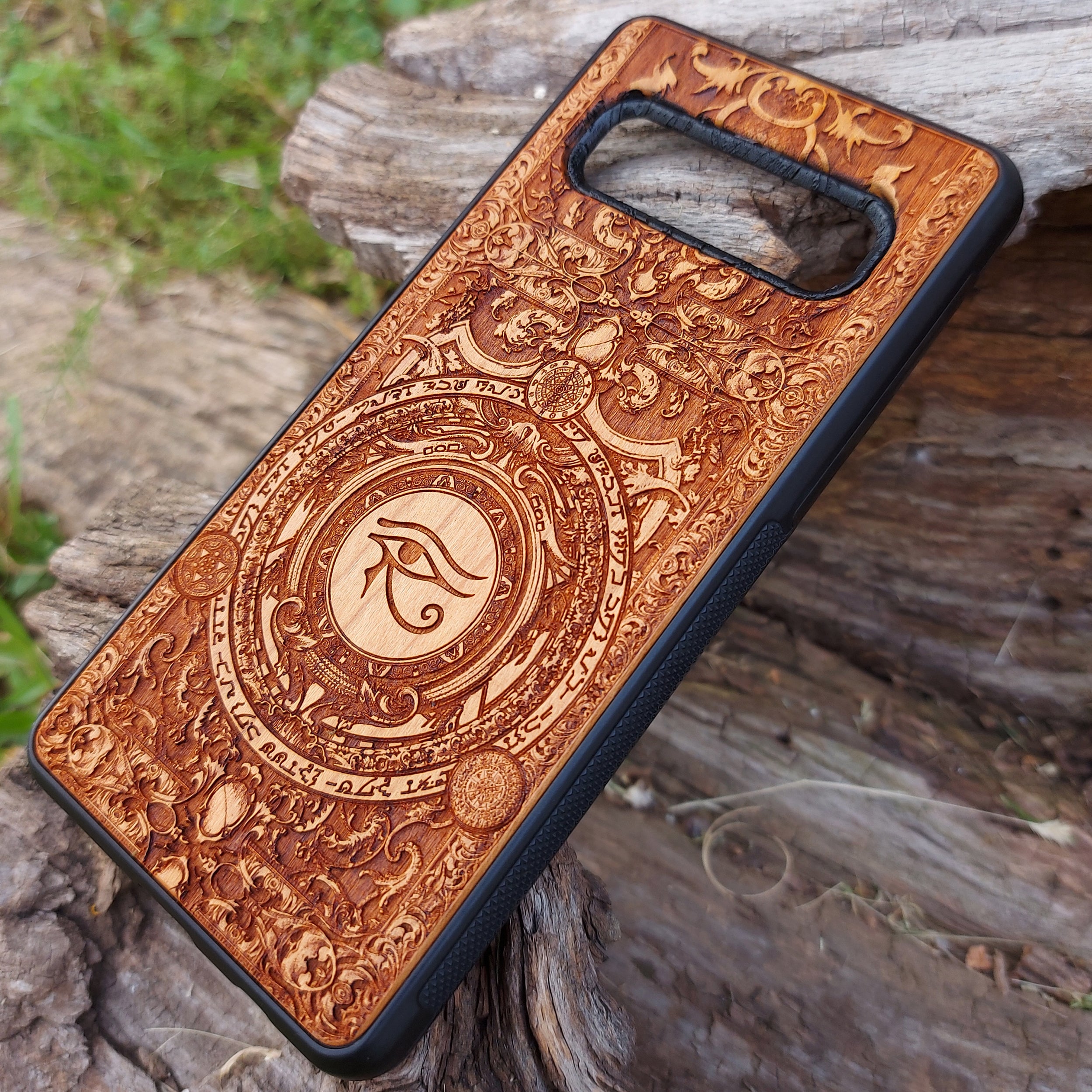 Handcrafted wooden phone case featuring the Eye of Ra symbol intricately engraved with ancient Egyptian-inspired detailing. Designed for iPhone , 15, 14, 13, 12, 11, Pro Max, Mini, and Samsung Galaxy S, S24, S23, S22, S21, S20 Ultra, Plus, Note 20 models. A unique fusion of art and protection for those who admire Egyptian mythology and premium craftsmanship.