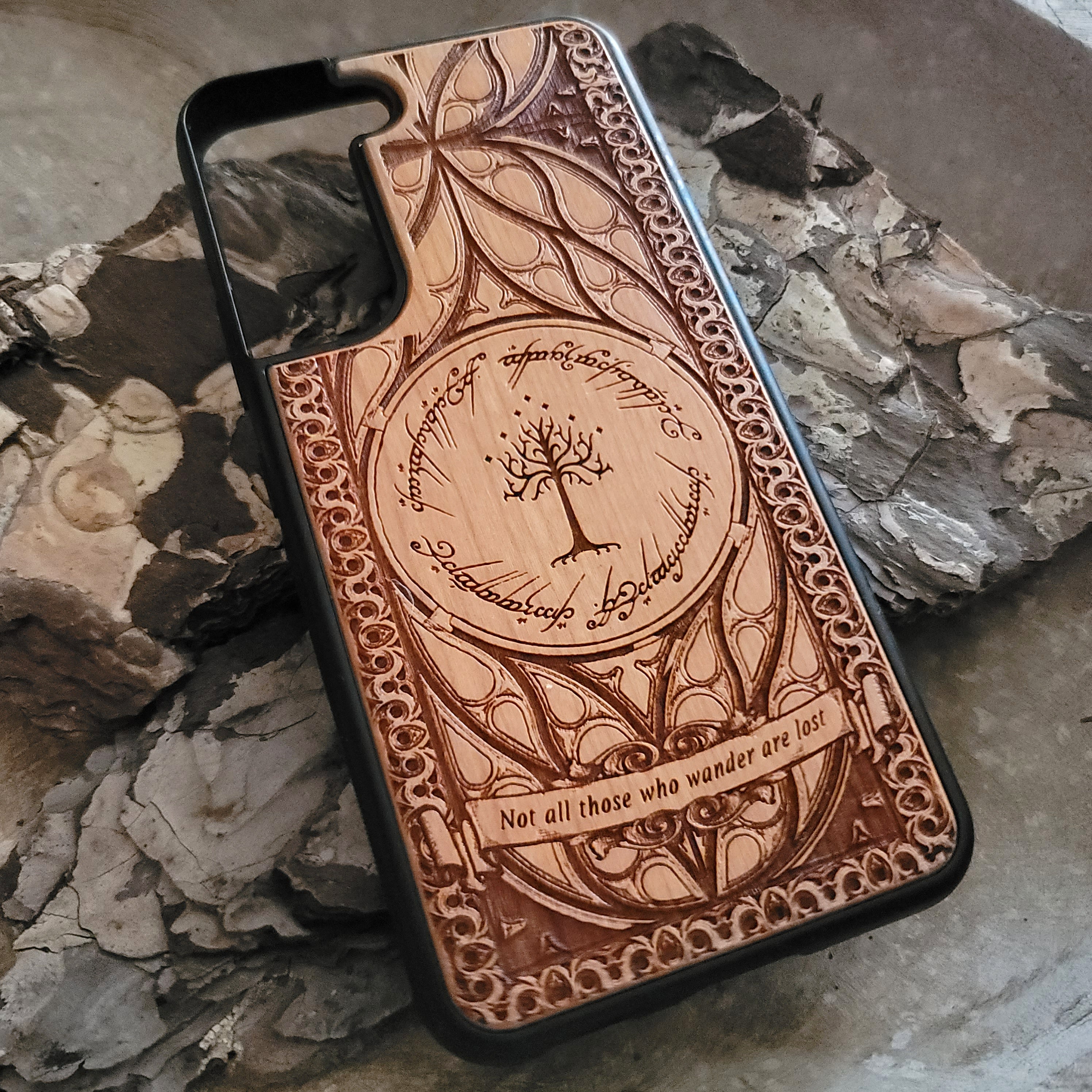 Lord of the Rings wood phone case featuring the White Tree of Gondor, Elvish script, and the iconic quote 'Not all those who wander are lost.' Laser-engraved with intricate detailing, this durable and elegant case is compatible with iPhone , 15, 14, 13, 12, 11, Pro Max, Mini, and Samsung Galaxy S, S24, S23, S22, S21, S20 Ultra, Plus, Note 20. A unique protective accessory for Tolkien fans.
