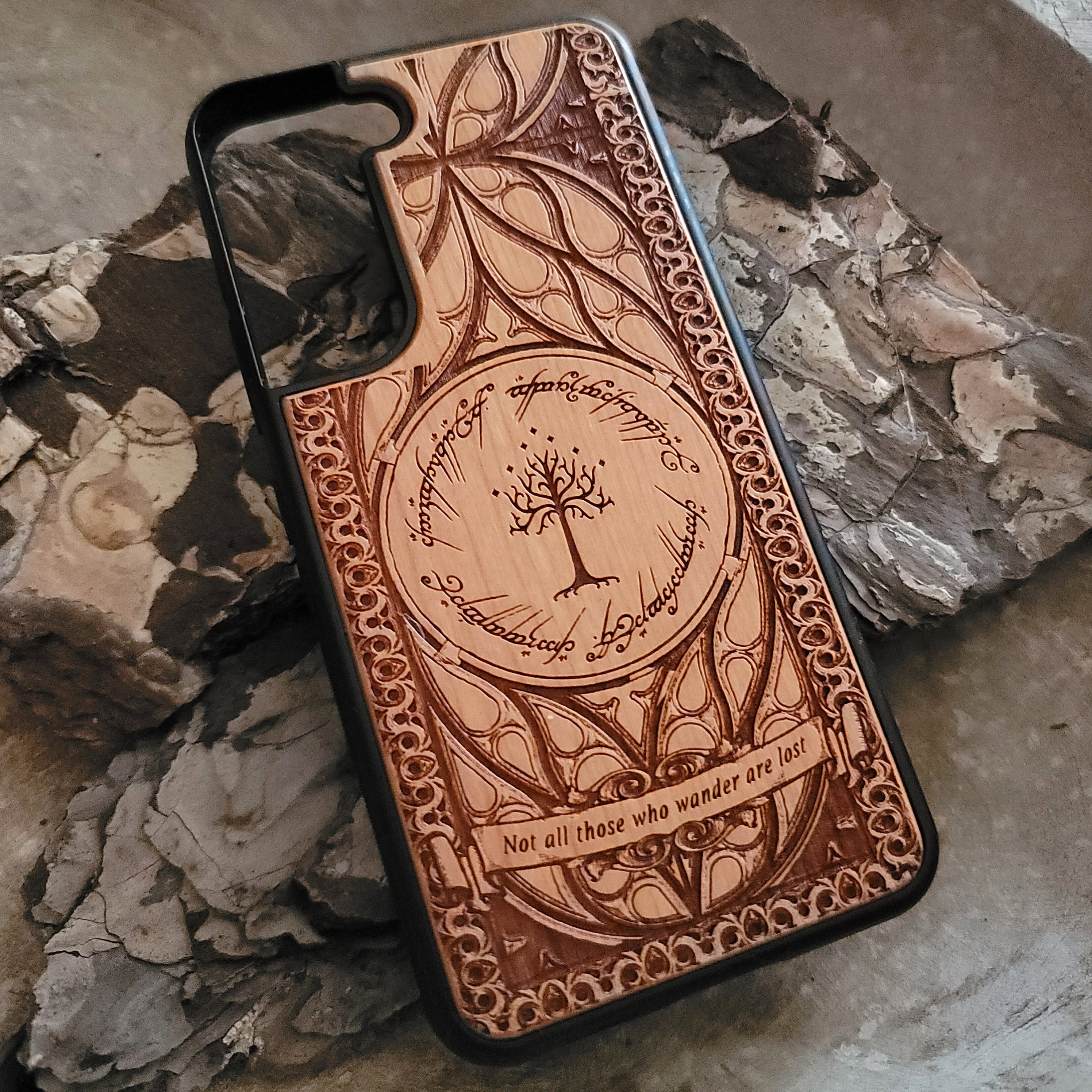 Lord of the Rings wood phone case featuring the White Tree of Gondor, Elvish script, and the iconic quote 'Not all those who wander are lost.' Laser-engraved with intricate detailing, this durable and elegant case is compatible with iPhone , 15, 14, 13, 12, 11, Pro Max, Mini, and Samsung Galaxy S, S24, S23, S22, S21, S20 Ultra, Plus, Note 20. A unique protective accessory for Tolkien fans.