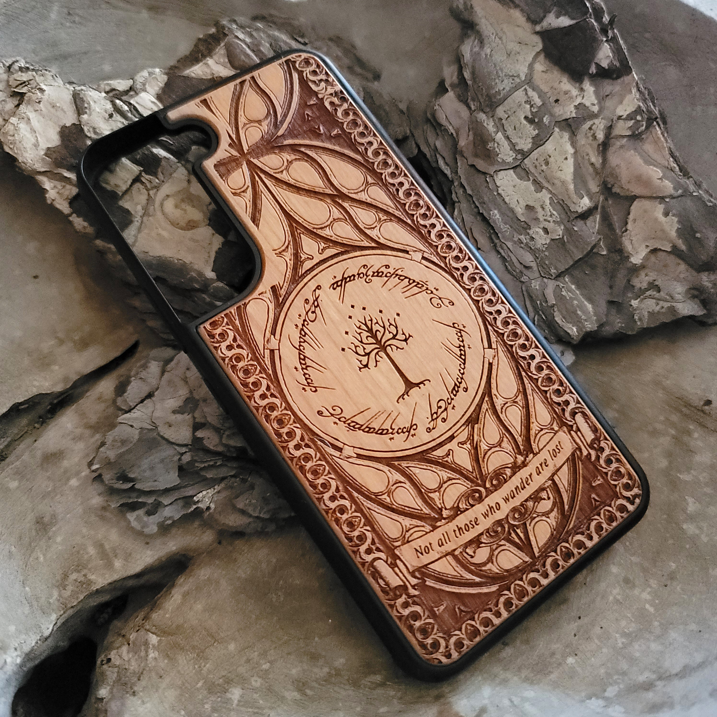 Lord of the Rings wood phone case featuring the White Tree of Gondor, Elvish script, and the iconic quote 'Not all those who wander are lost.' Laser-engraved with intricate detailing, this durable and elegant case is compatible with iPhone , 15, 14, 13, 12, 11, Pro Max, Mini, and Samsung Galaxy S, S24, S23, S22, S21, S20 Ultra, Plus, Note 20. A unique protective accessory for Tolkien fans.