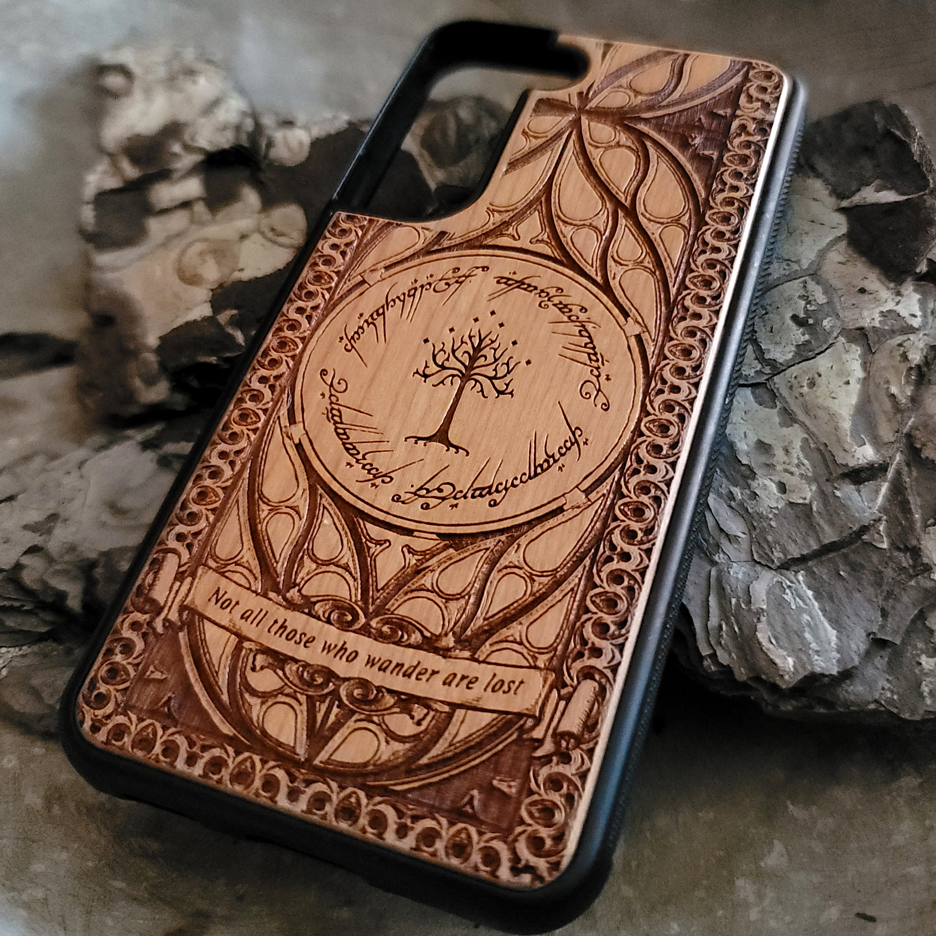 Lord of the Rings wood phone case featuring the White Tree of Gondor, Elvish script, and the iconic quote 'Not all those who wander are lost.' Laser-engraved with intricate detailing, this durable and elegant case is compatible with iPhone , 15, 14, 13, 12, 11, Pro Max, Mini, and Samsung Galaxy S, S24, S23, S22, S21, S20 Ultra, Plus, Note 20. A unique protective accessory for Tolkien fans.
