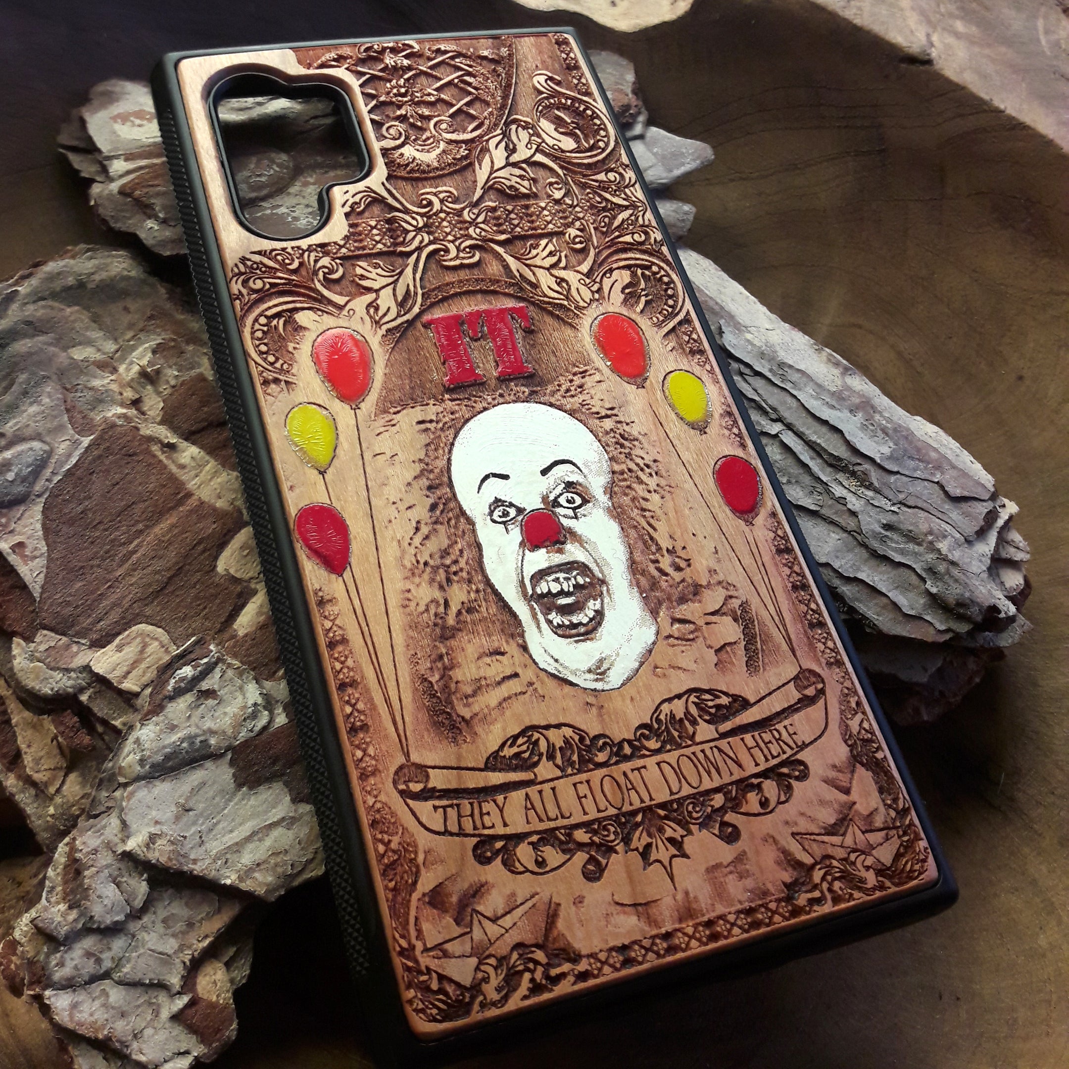 Laser-engraved horror-themed wooden phone case featuring a detailed skull design