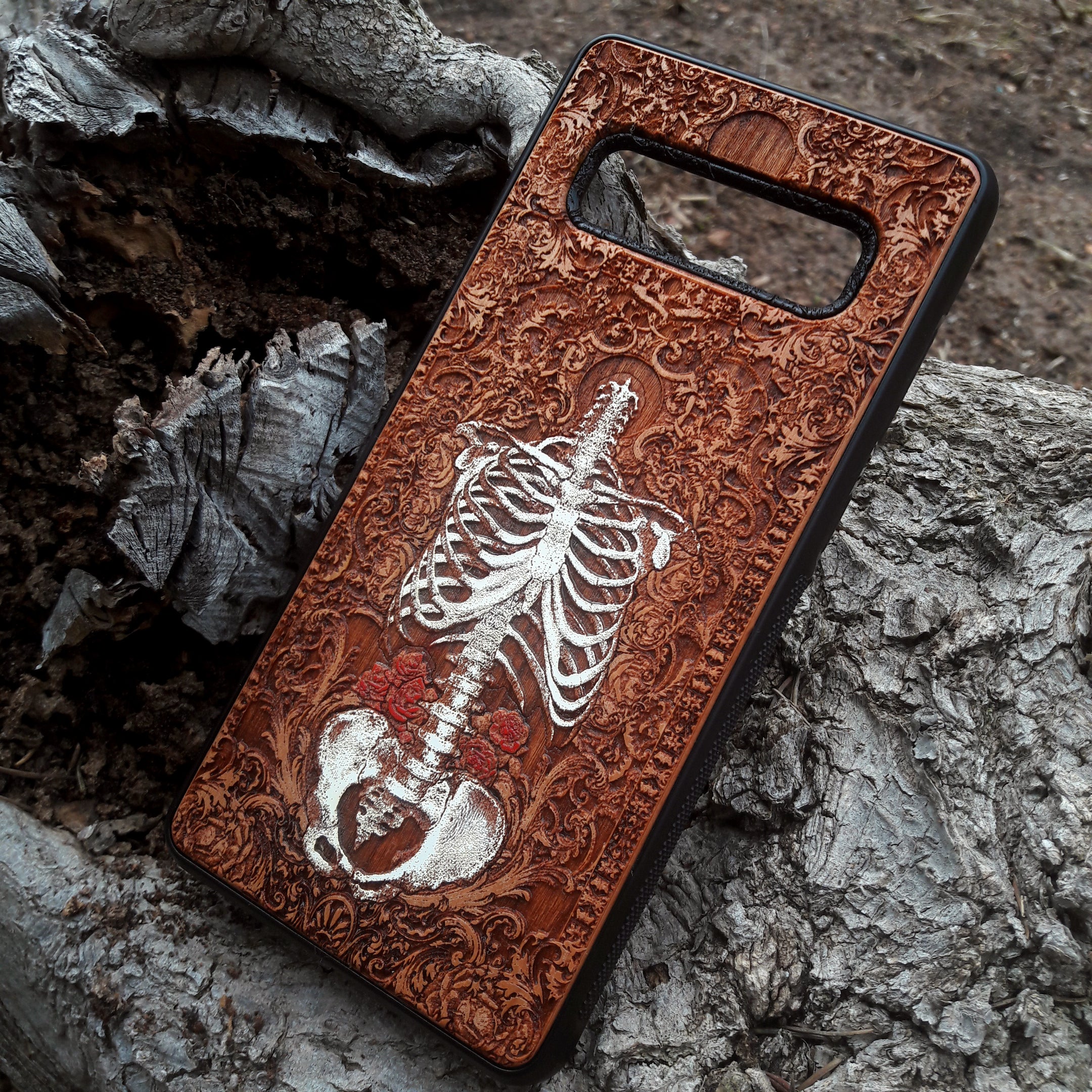 Laser-engraved anatomical human skeleton design on a wooden phone case, compatible with iPhone 16, iPhone 15, Galaxy S25, and more.