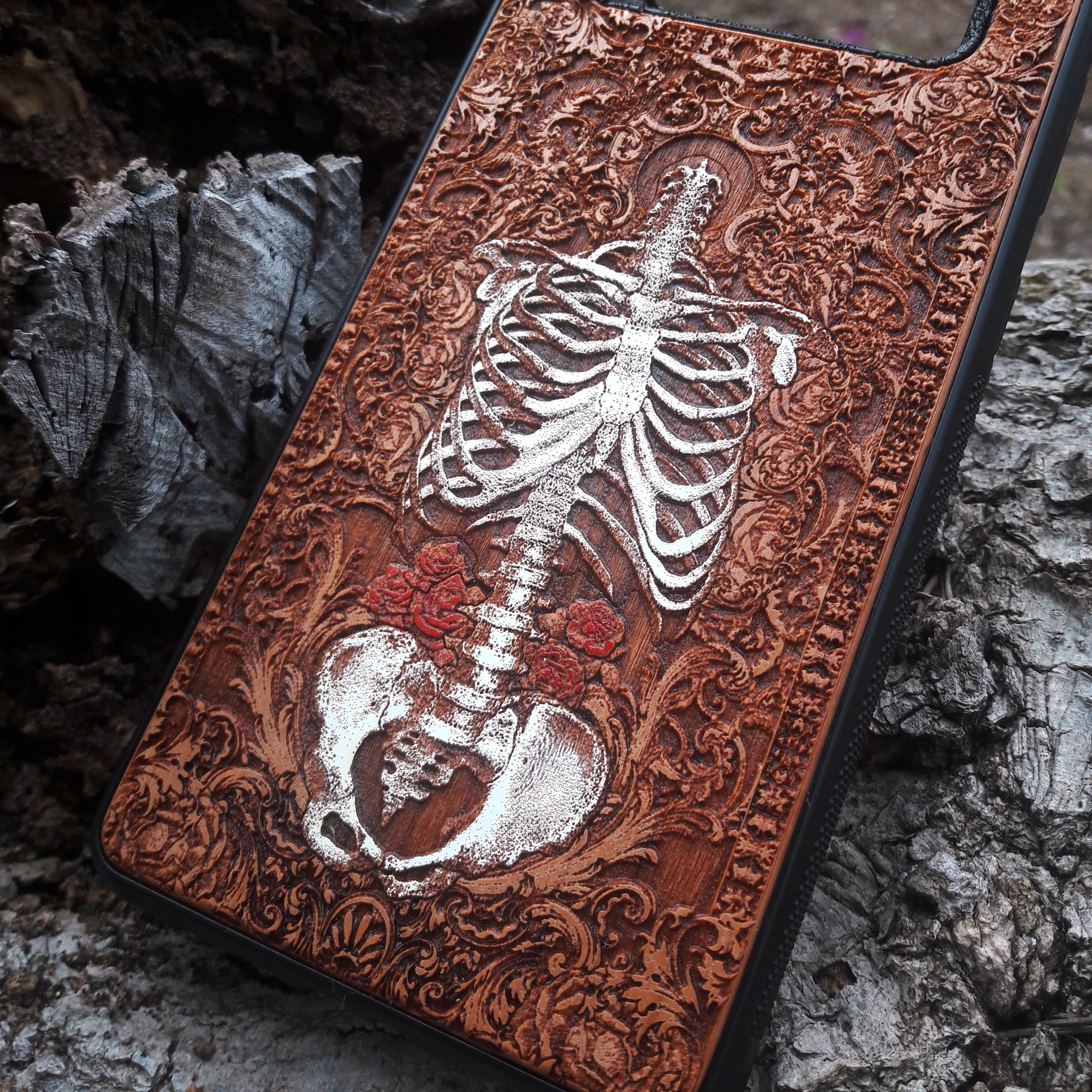 Laser-engraved anatomical human skeleton design on a wooden phone case, compatible with iPhone 16, iPhone 15, Galaxy S25, and more.