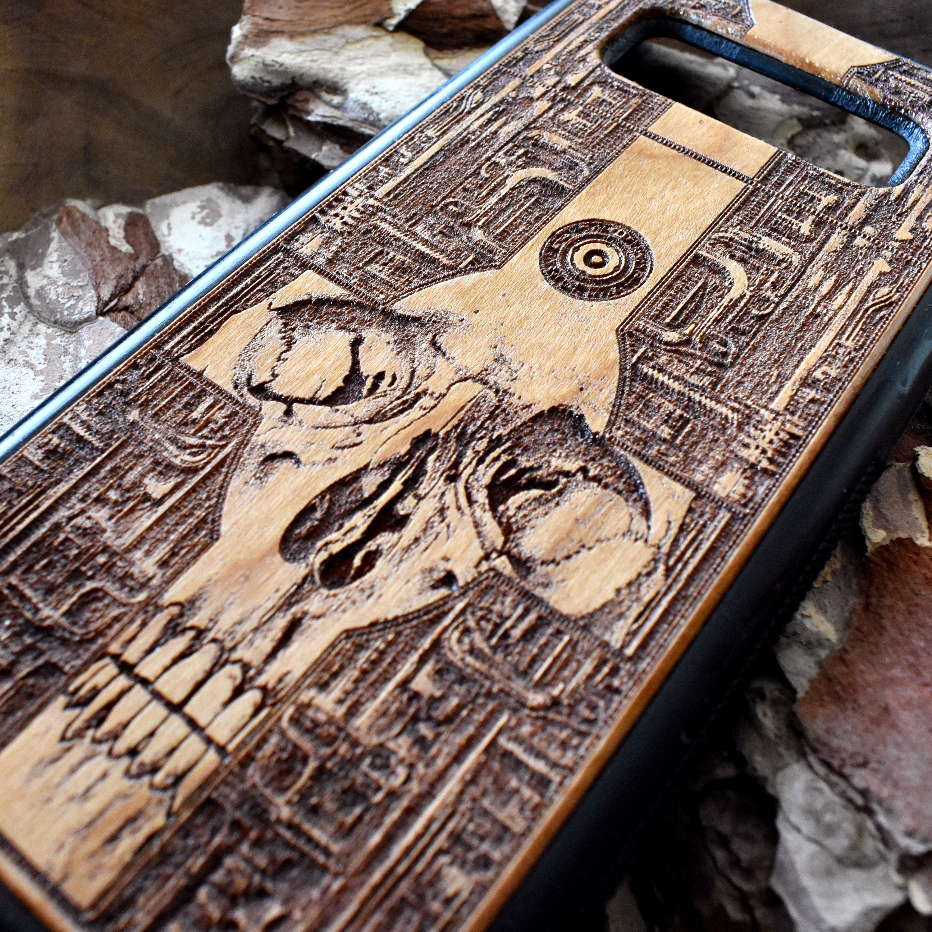 Wooden phone case with a detailed gothic skull design, laser-engraved for iPhone , iPhone 15, Galaxy S, Note 20, and more. A unique, durable accessory for fans of dark art.