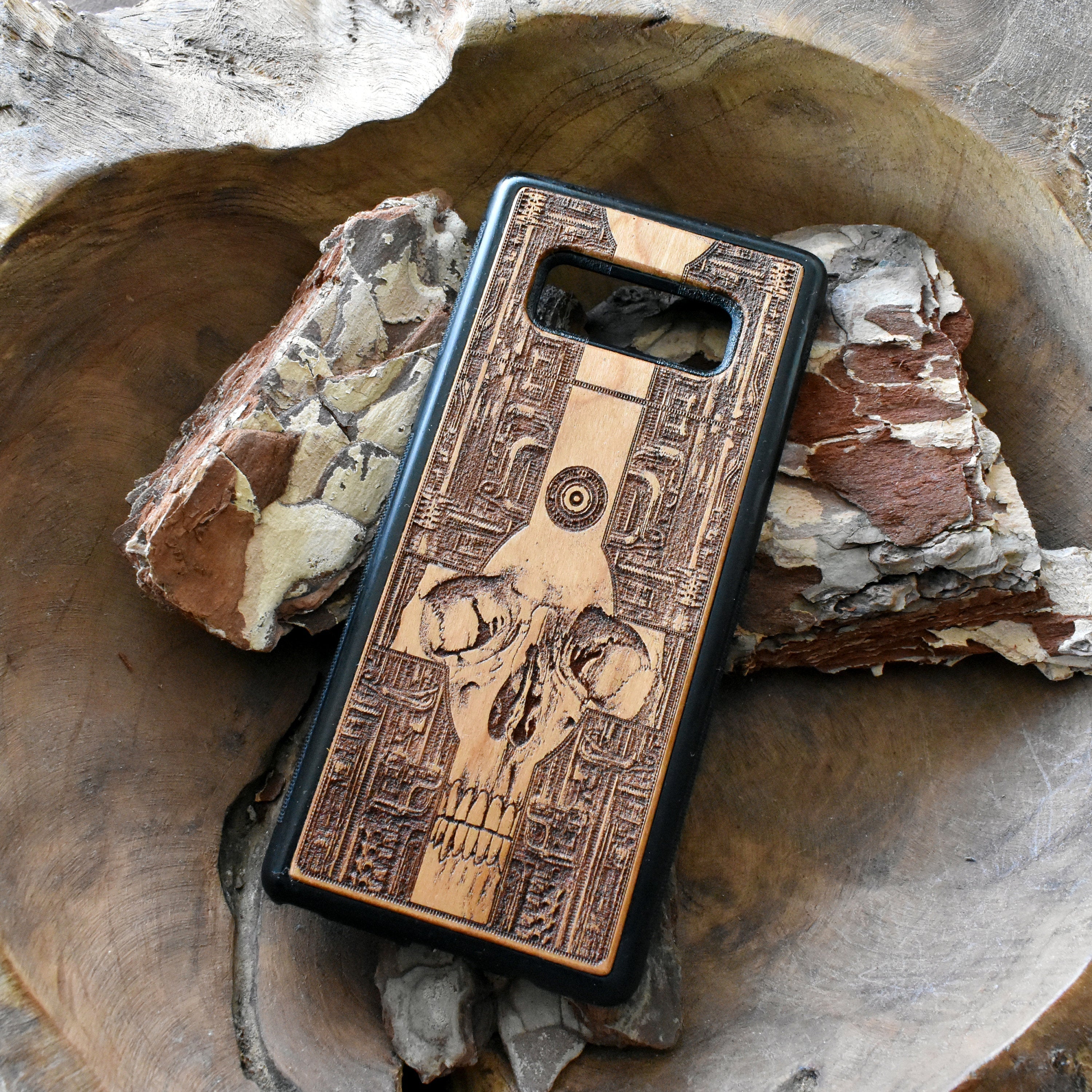 Wooden phone case with a detailed gothic skull design, laser-engraved for iPhone , iPhone 15, Galaxy S, Note 20, and more. A unique, durable accessory for fans of dark art.