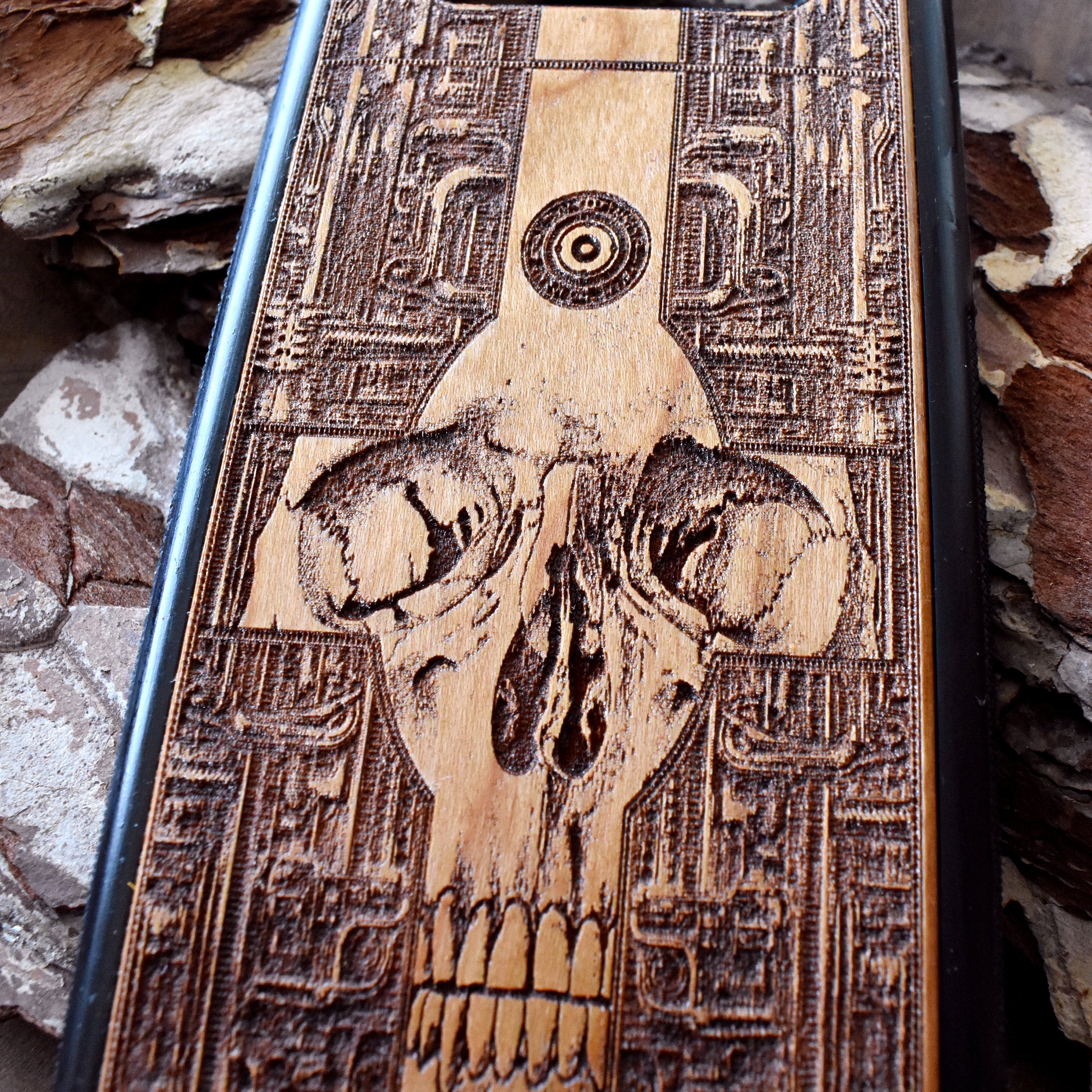 Wooden phone case with a detailed gothic skull design, laser-engraved for iPhone , iPhone 15, Galaxy S, Note 20, and more. A unique, durable accessory for fans of dark art.