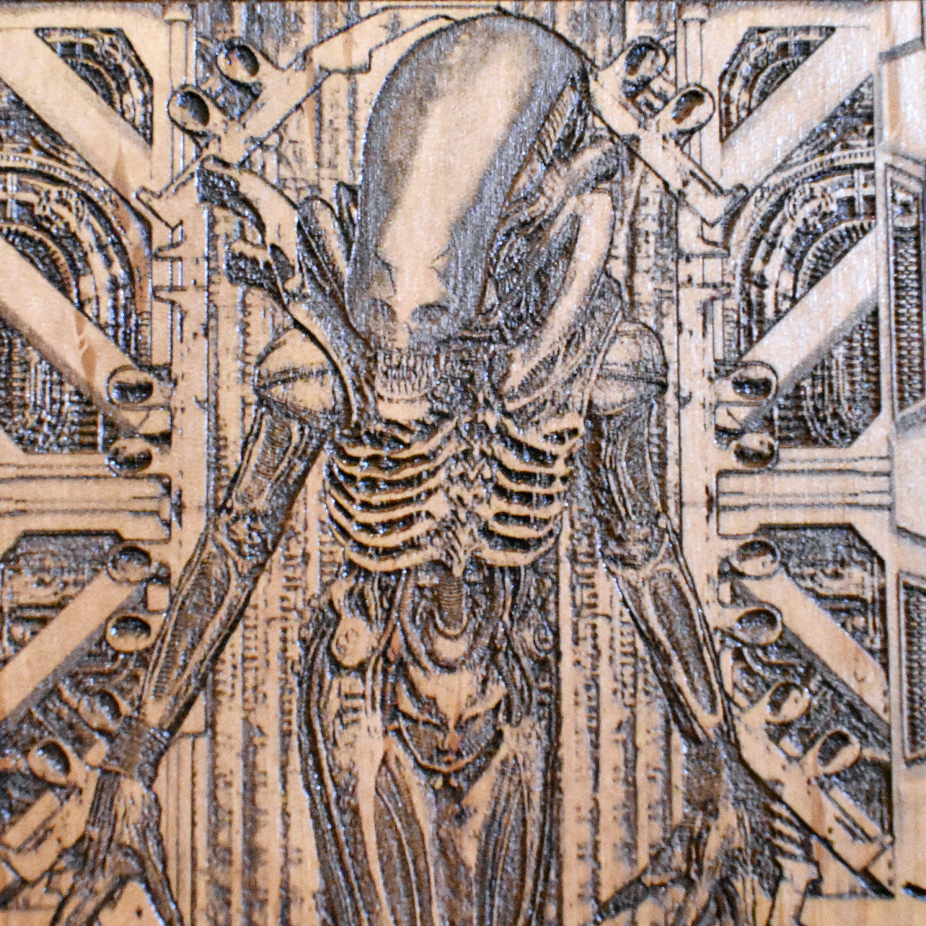 Intricately engraved Xenomorph wooden plaque, detailed laser art piece.