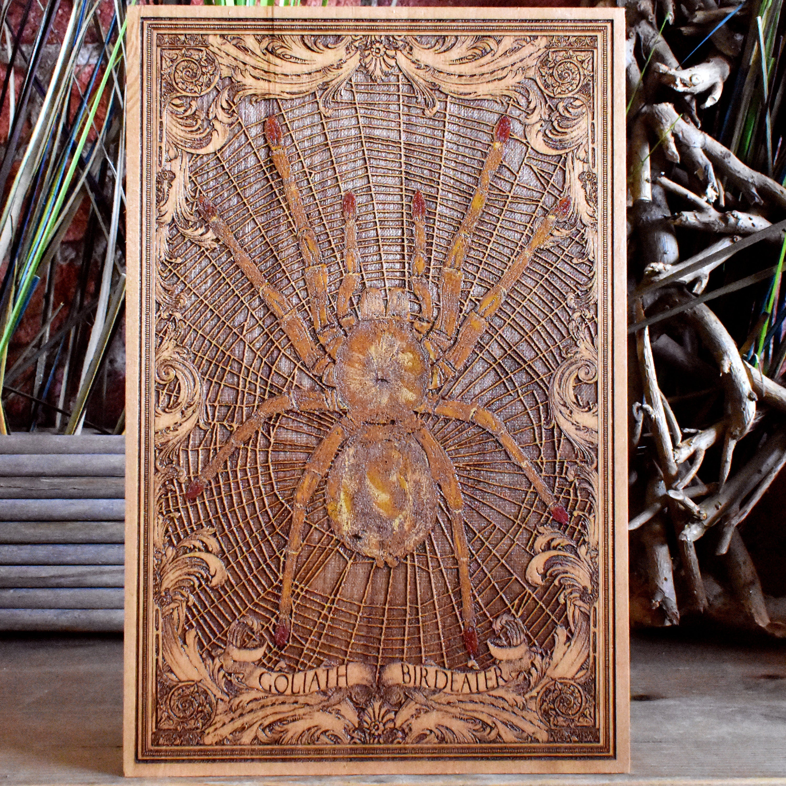 Hand-painted Goliath Birdeater spider on engraved wood, realistic horror decor.