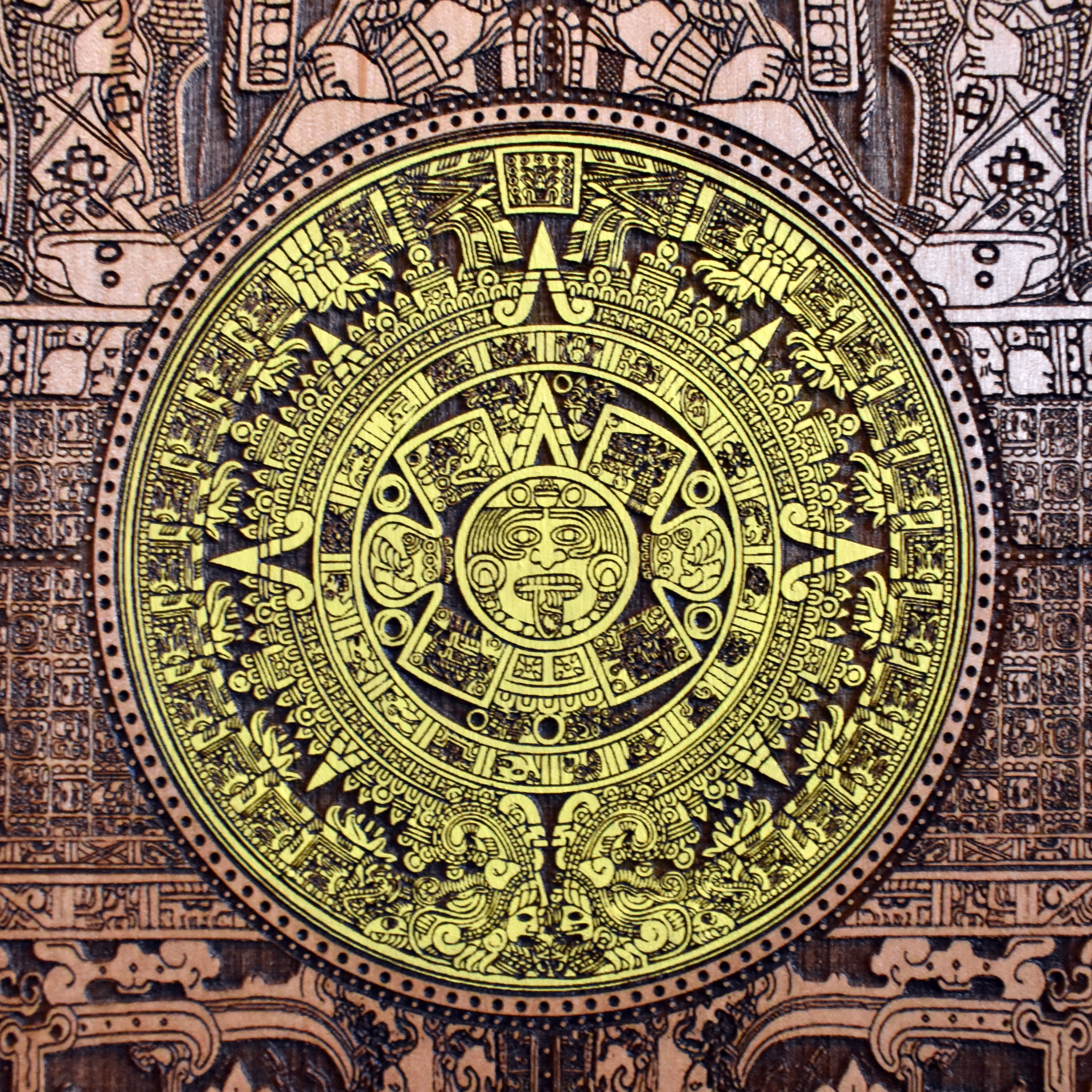 Colorful Aztec sun stone wall art, laser-engraved and hand-painted wood.