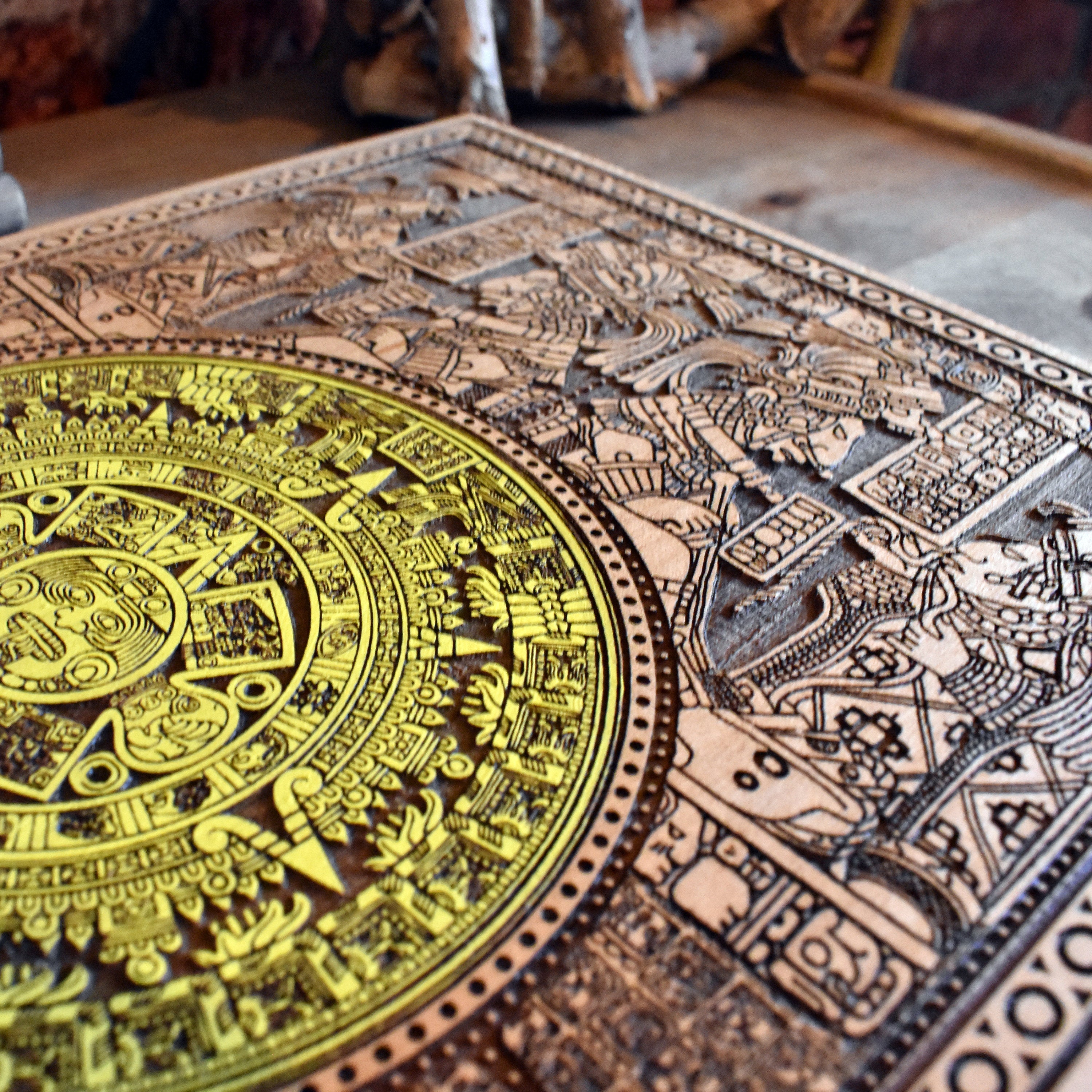 Mesoamerican Aztec calendar art, engraved and painted on wooden plaque.