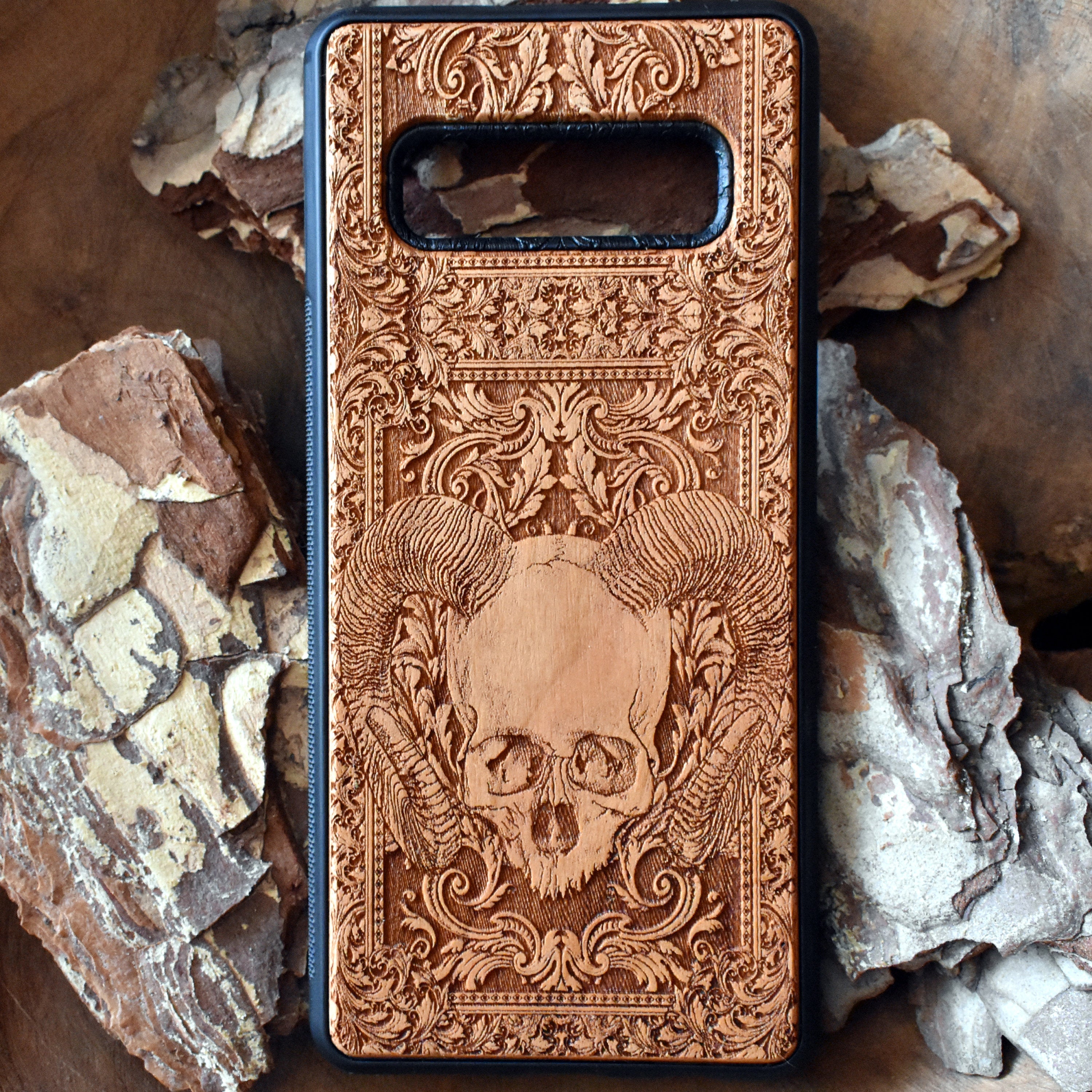 Skull and ram horns laser-engraved wooden phone case for iPhone & Samsung Galaxy – Compatible with iPhone  and Samsung Galaxy S
This optimization focuses on the dark, gothic, and alternative elements of the design, including the skull and ram horns theme, while also highlighting the compatibility with both iPhone and Samsung Galaxy models for better search engine visibility.