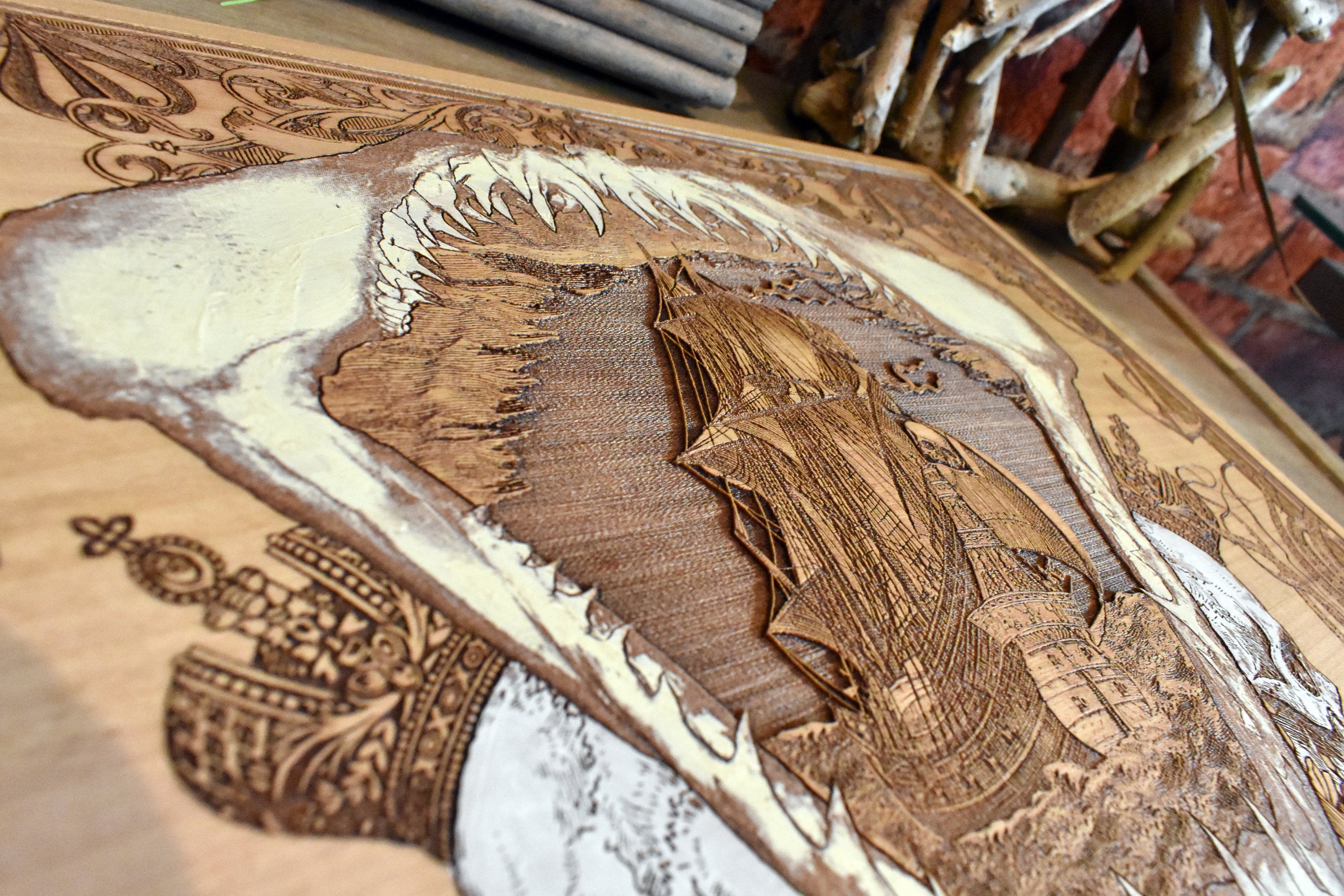 Shark mouth silhouette with pirate ship engraving, dark wood wall plaque.