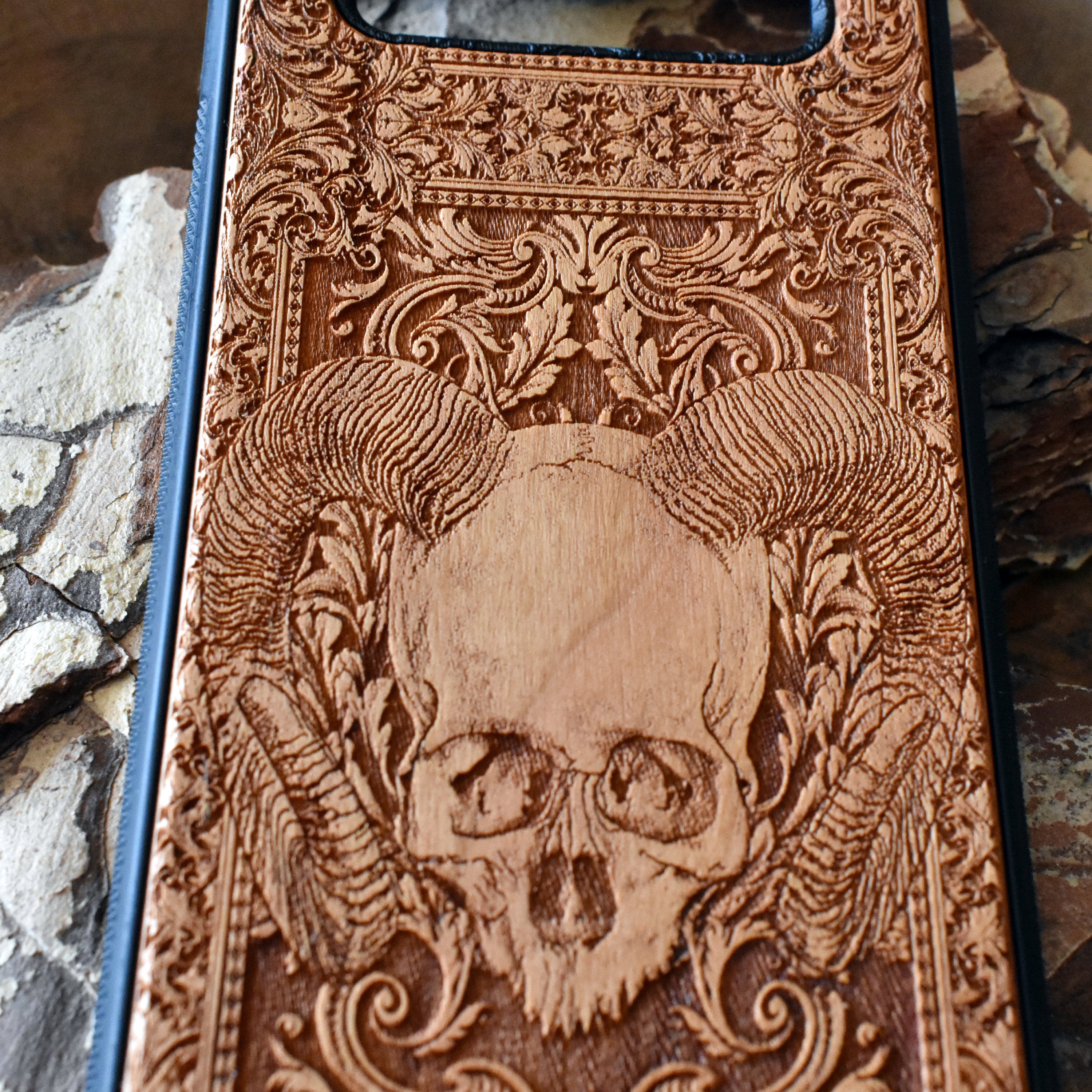 Skull and ram horns laser-engraved wooden phone case for iPhone & Samsung Galaxy – Compatible with iPhone  and Samsung Galaxy S
This optimization focuses on the dark, gothic, and alternative elements of the design, including the skull and ram horns theme, while also highlighting the compatibility with both iPhone and Samsung Galaxy models for better search engine visibility.