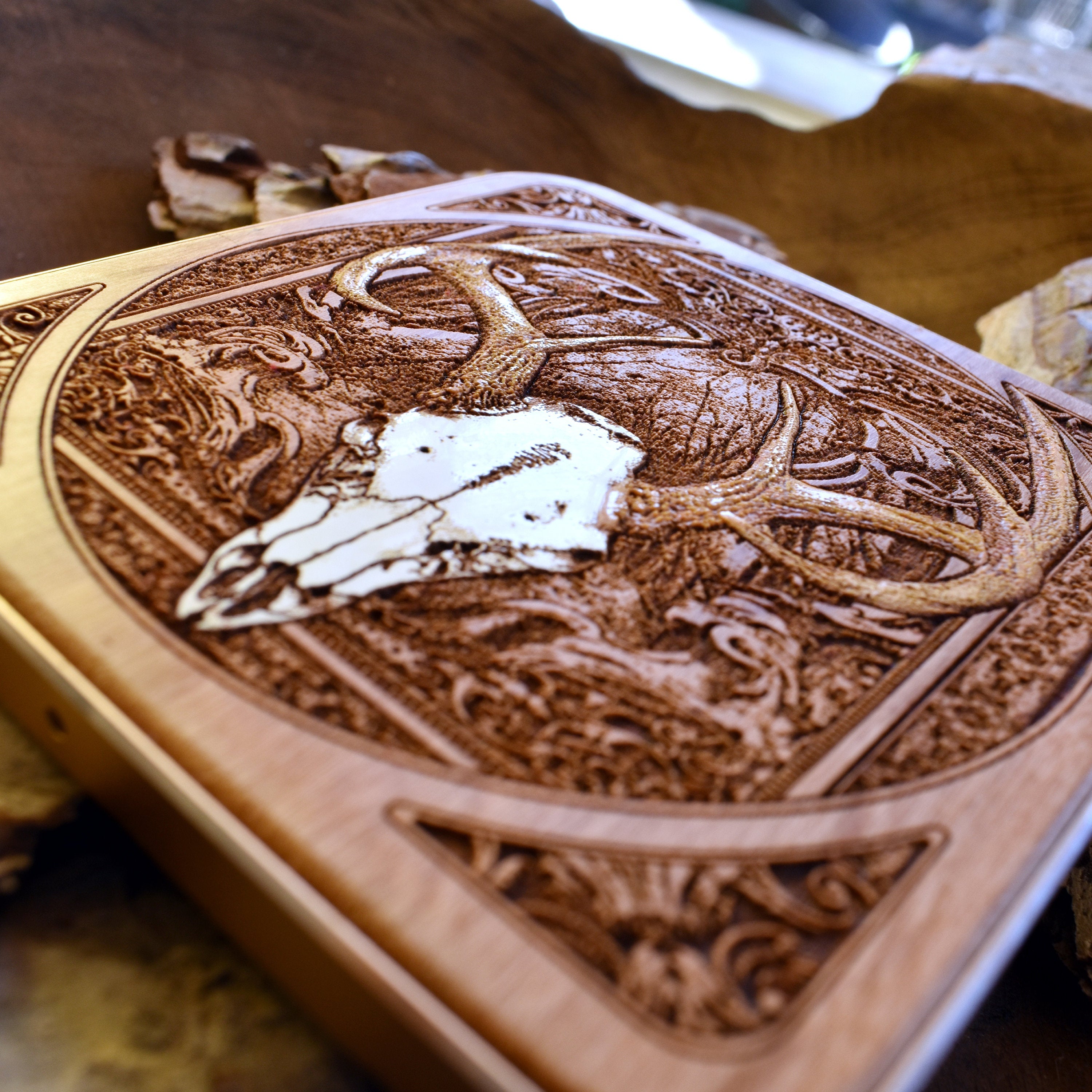 Artistic workspace with hand-painted deer skull wireless charger centerpiece.