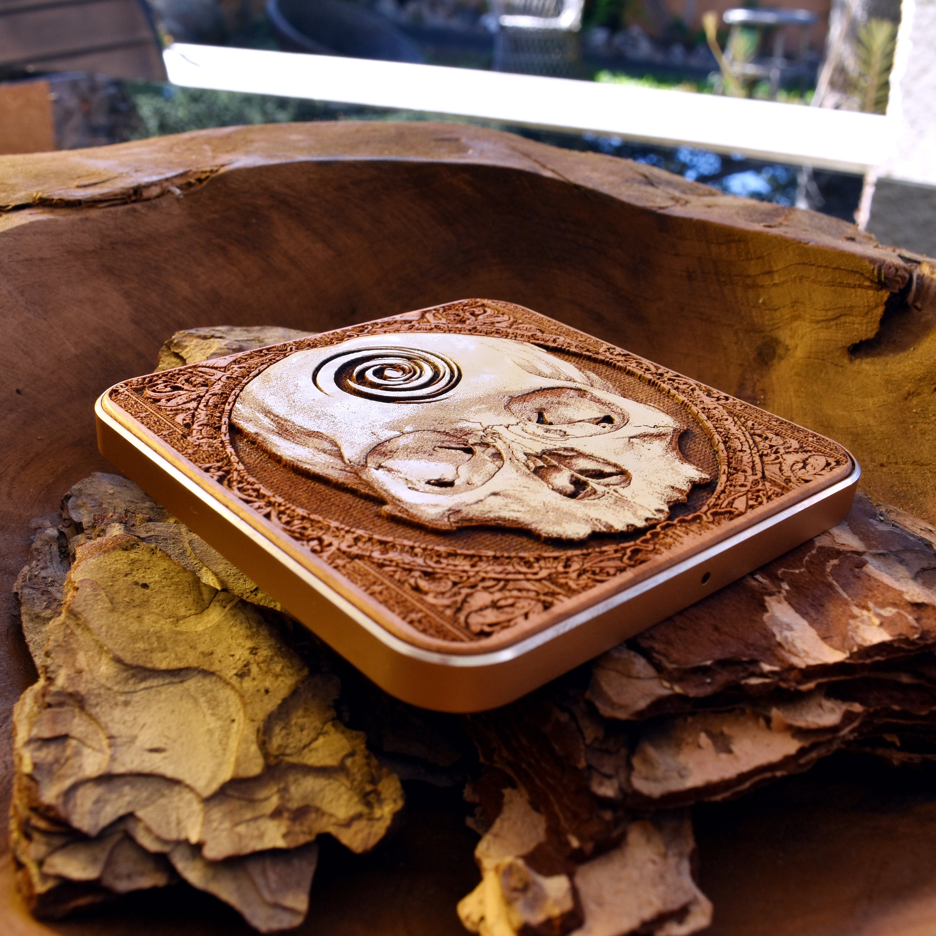 Slim profile skull dark art wireless charger made of wood, fast charging for Galaxy S25 and iPhone 16 users.