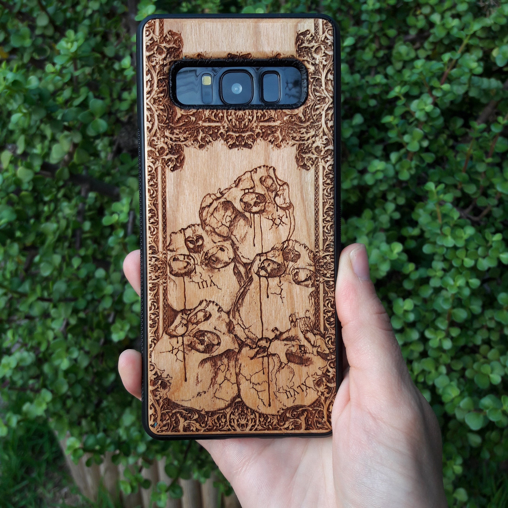 Wooden phone case with intricately carved skull design, ideal for iPhone , Samsung Galaxy S, Note 20, and more. A unique gothic accessory offering durable protection with artistic detail.