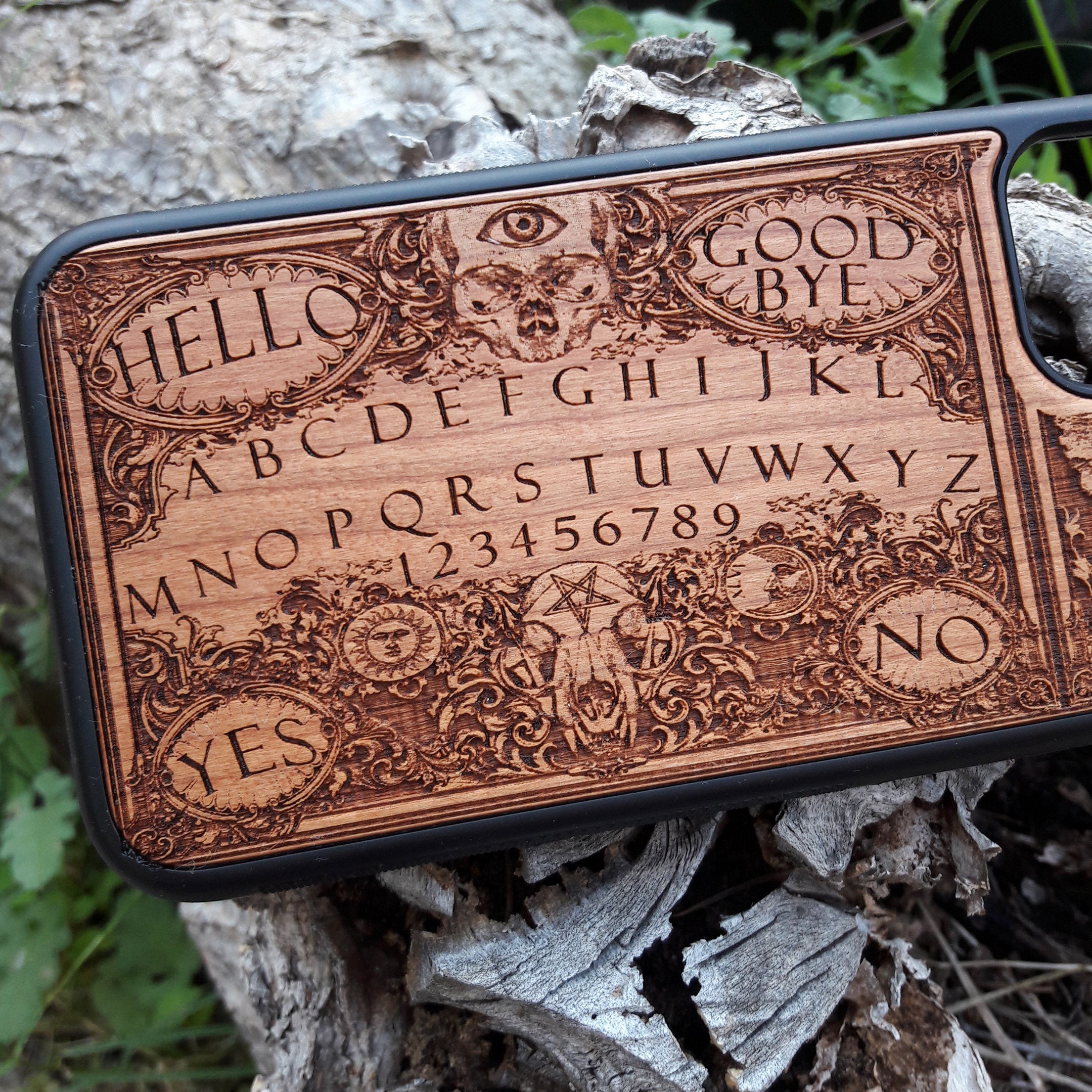 Handmade Ouija Board-inspired wood phone case, perfect for collectors