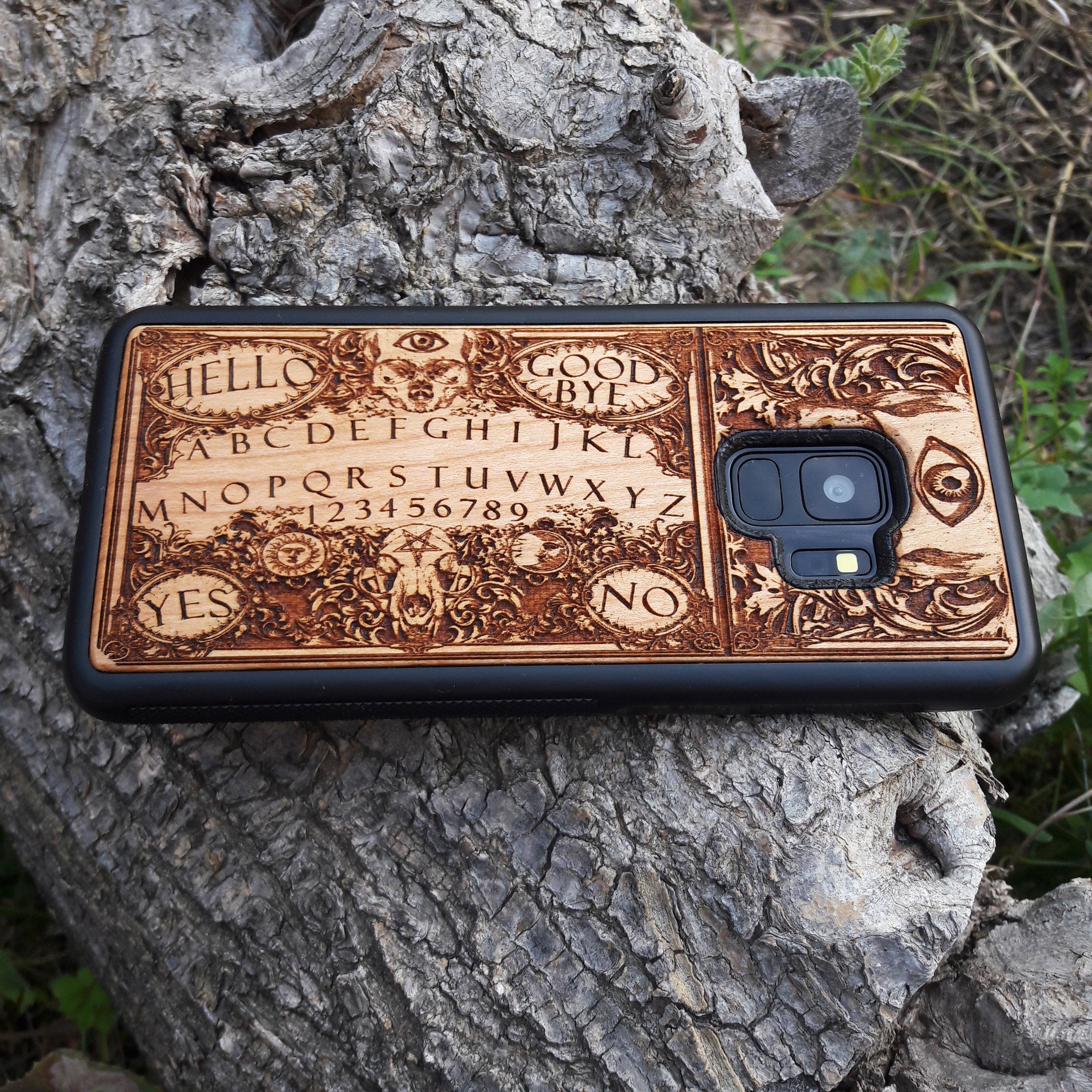 Handmade Ouija Board-inspired wood phone case, perfect for collectors