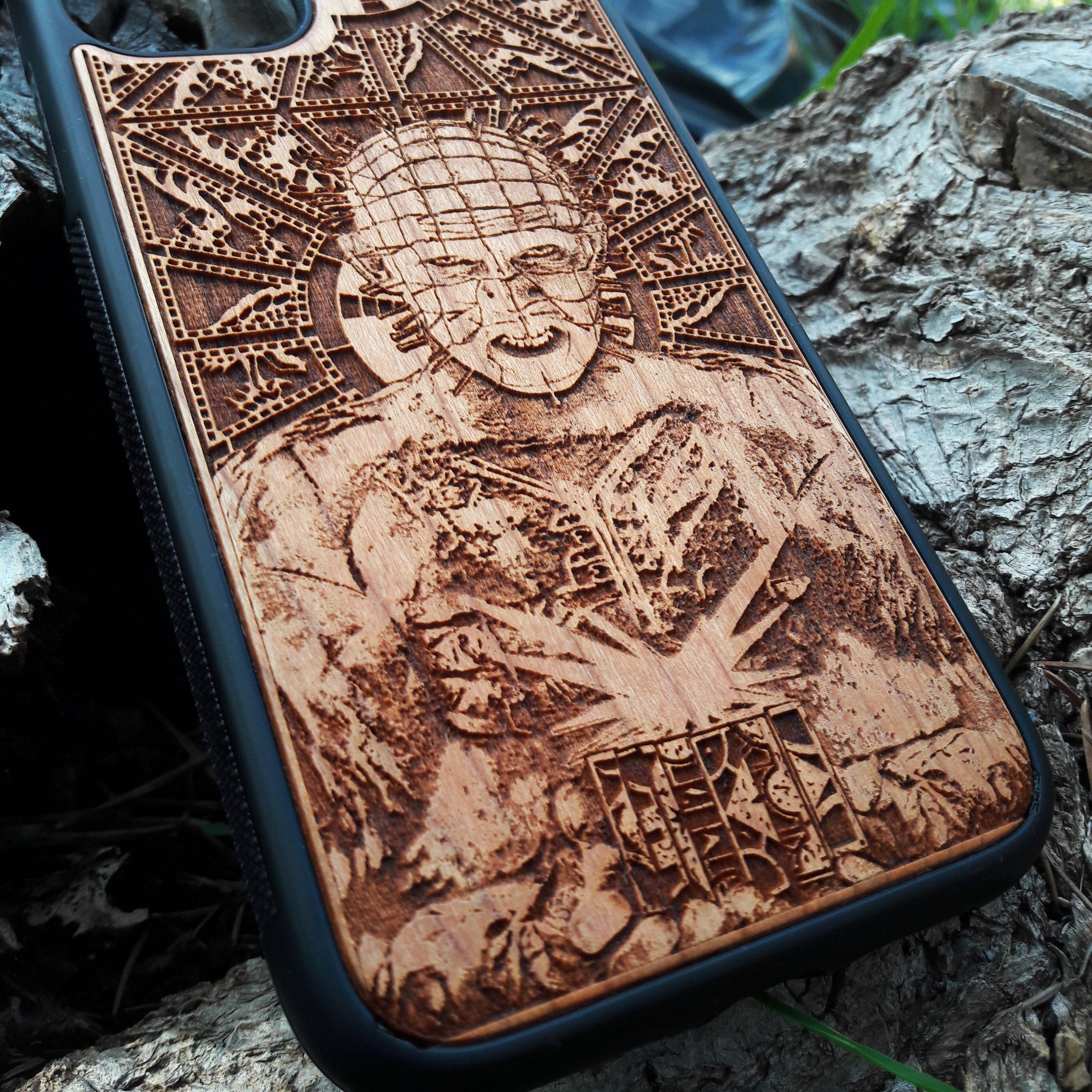 Pinhead-inspired wood phone case for iPhone , 15, 14, 13, 12, 11 Pro Max, Mini & Samsung Galaxy S, S24, S23, S22, S21, S20 Ultra Plus, Note 20 with intricate laser engraving design from Hellraiser. Durable, sleek, and unique, perfect for horror movie fans.