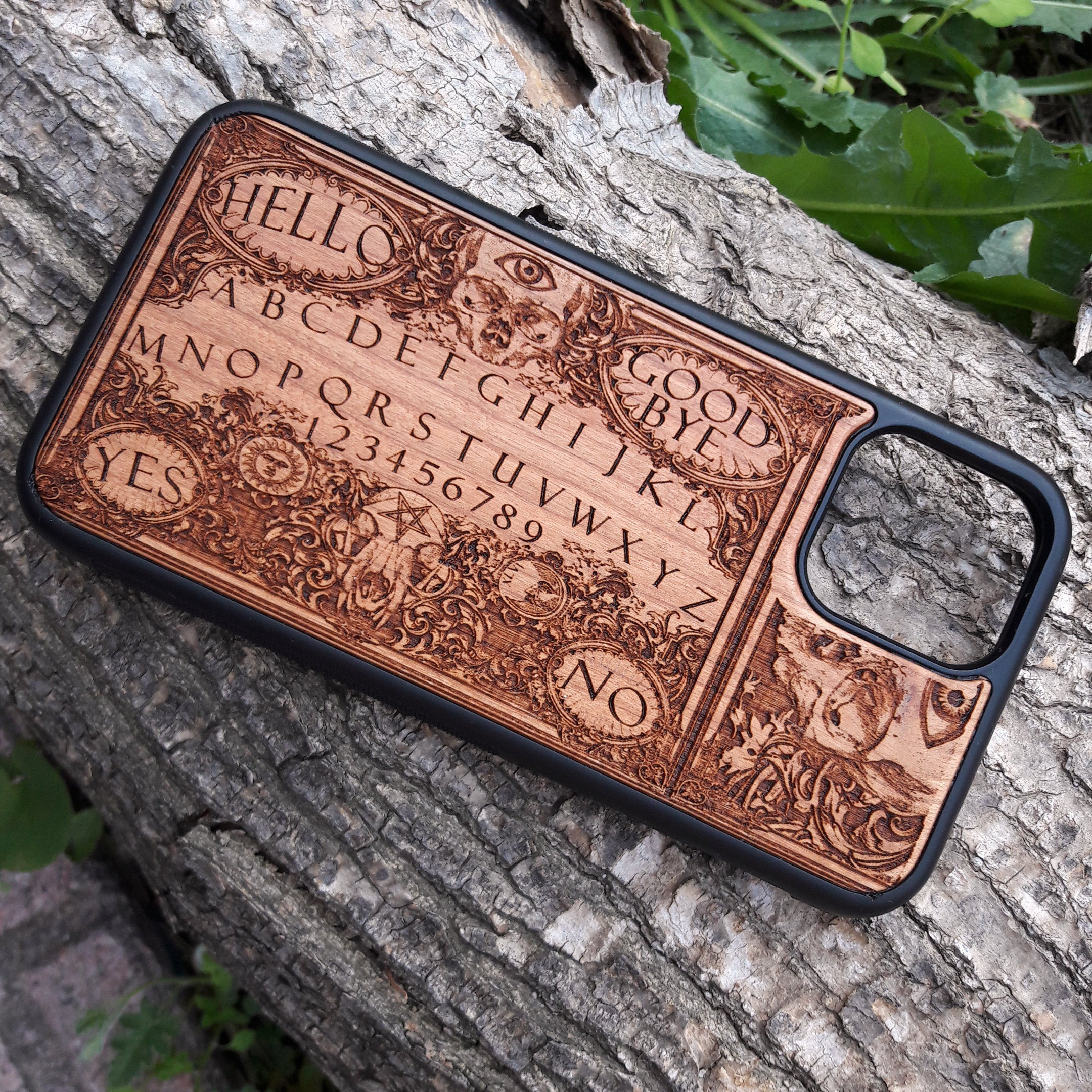 Handmade Ouija Board-inspired wood phone case, perfect for collectors