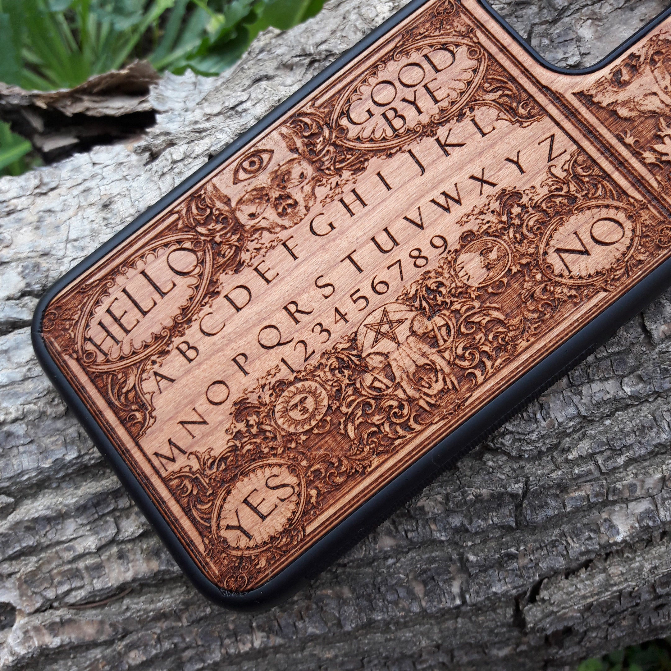 Handmade Ouija Board-inspired wood phone case, perfect for collectors