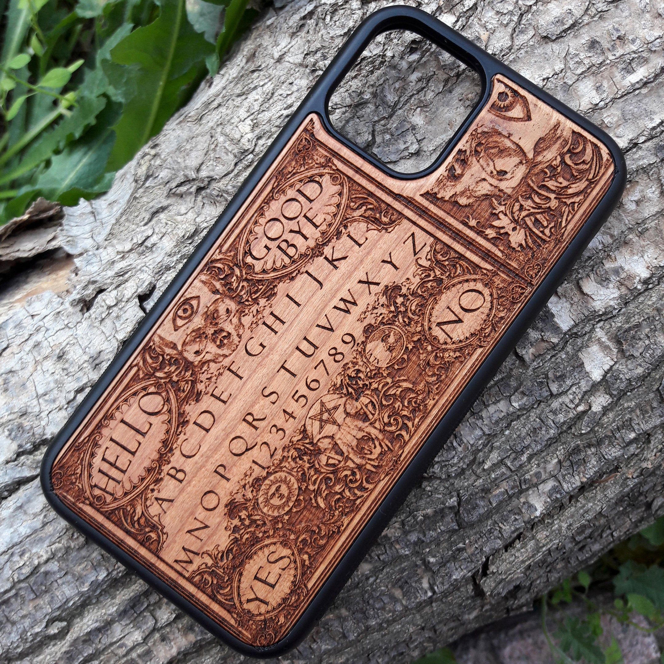 Handmade Ouija Board-inspired wood phone case, perfect for collectors