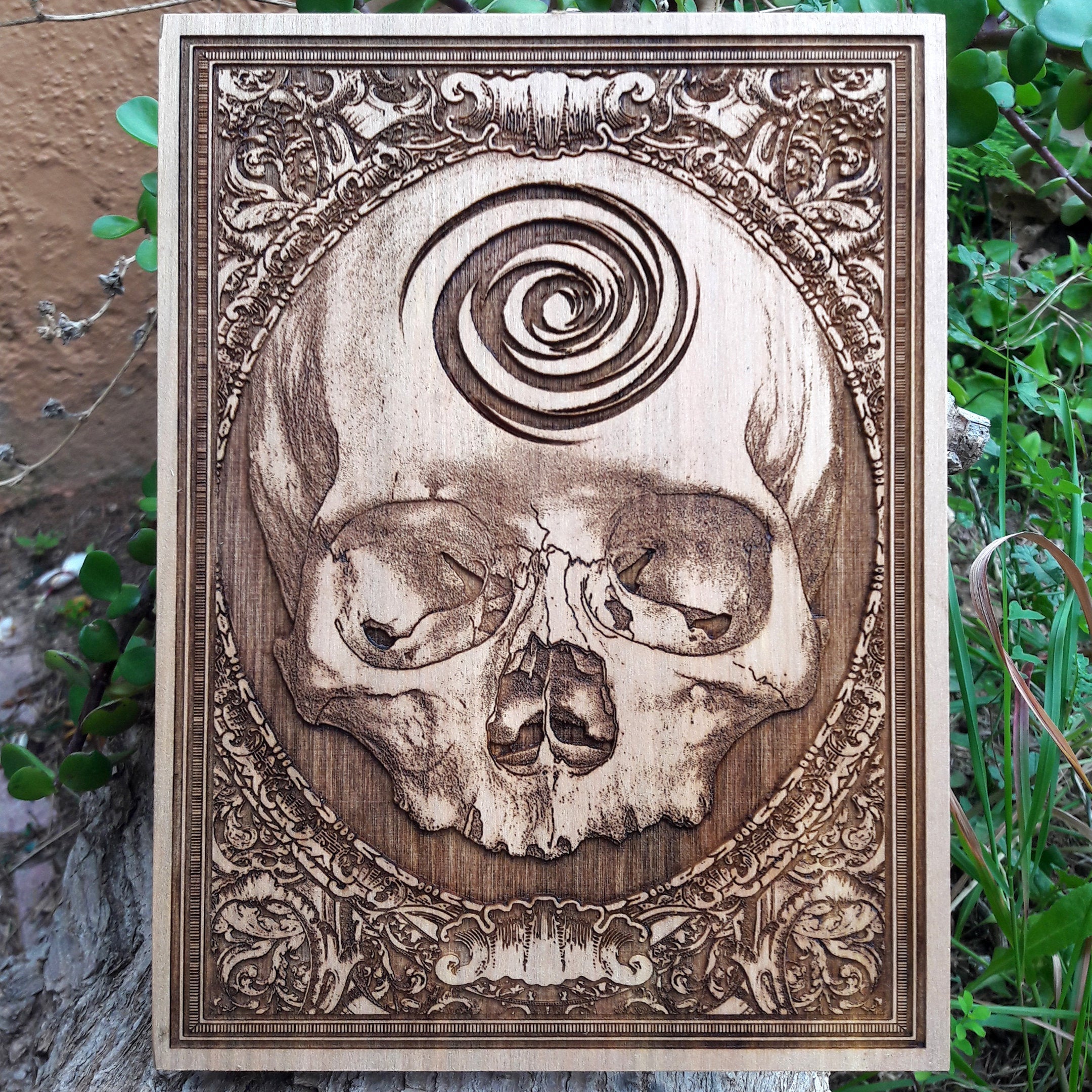 Handcrafted gothic skull artwork on wood, perfect for dark home decor and alternative wall art.