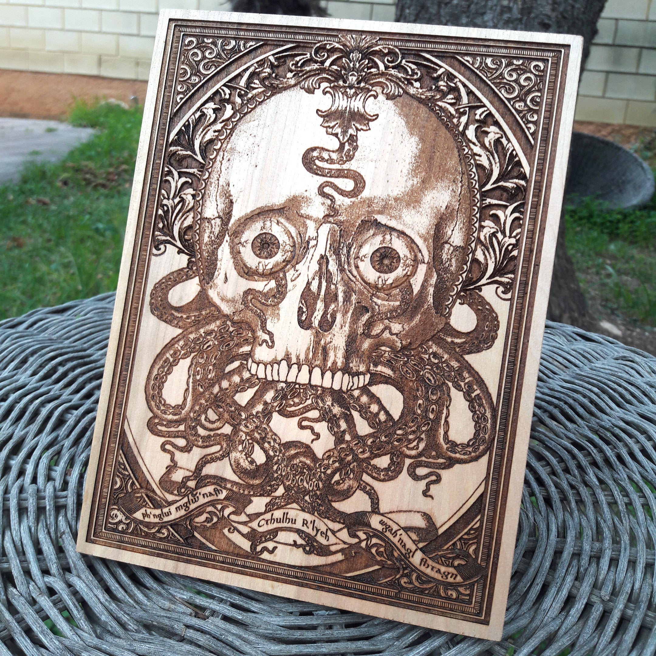 Dark Cthulhu skull engraving on wood, eerie Lovecraft wall art for gothic decor lovers.