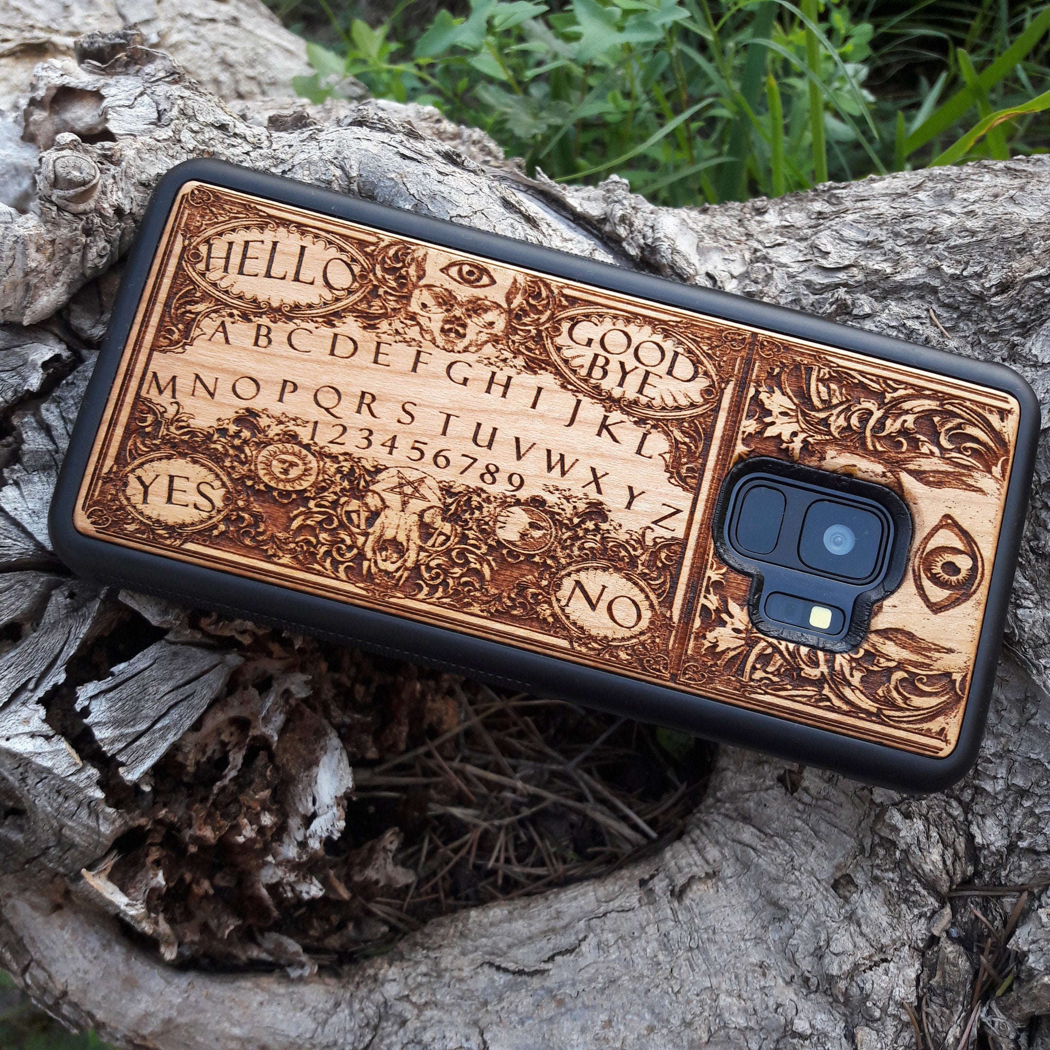 Handmade Ouija Board-inspired wood phone case, perfect for collectors