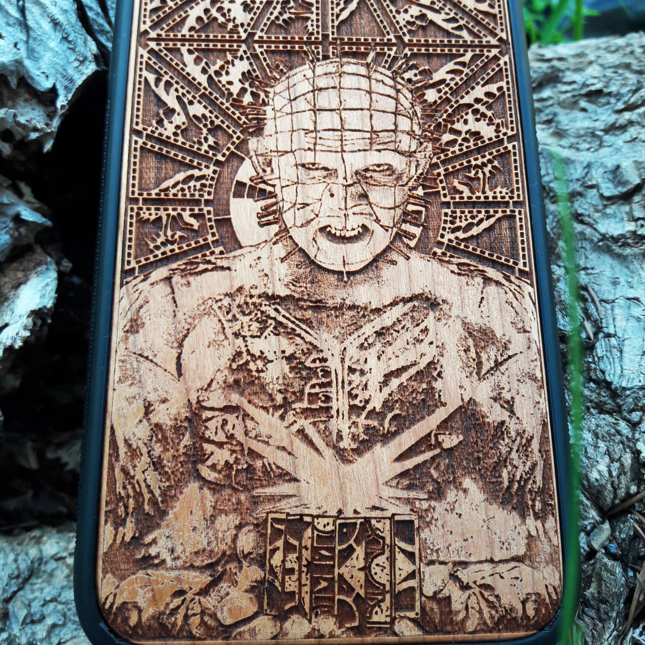 Pinhead-inspired wood phone case for iPhone , 15, 14, 13, 12, 11 Pro Max, Mini & Samsung Galaxy S, S24, S23, S22, S21, S20 Ultra Plus, Note 20 with intricate laser engraving design from Hellraiser. Durable, sleek, and unique, perfect for horror movie fans.