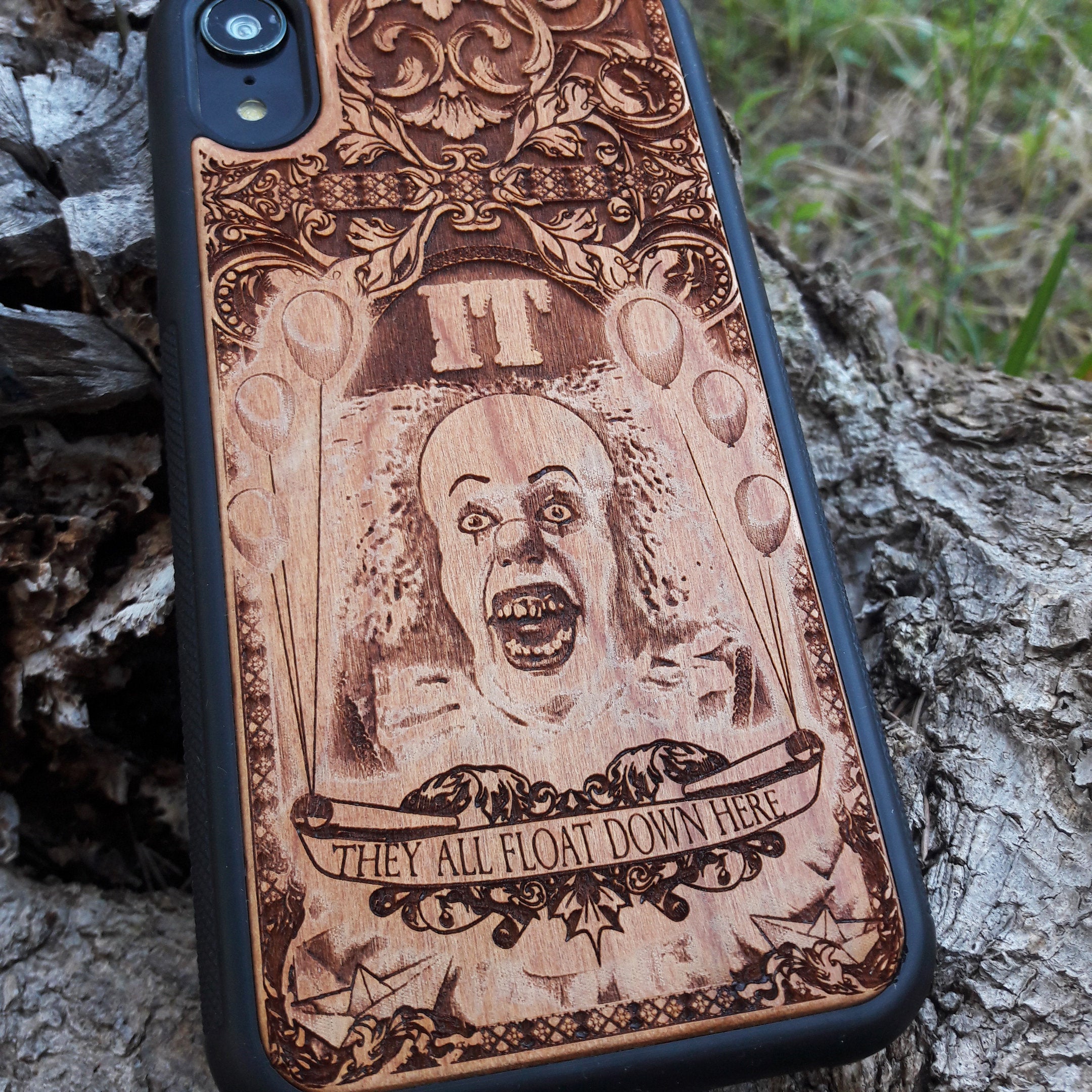 Wooden phone case with Stephen King's It clown design, intricately carved for iPhone , iPhone 15, Galaxy S, S24, Note 20, and more. Ideal for horror fans seeking unique protection and artistic style.