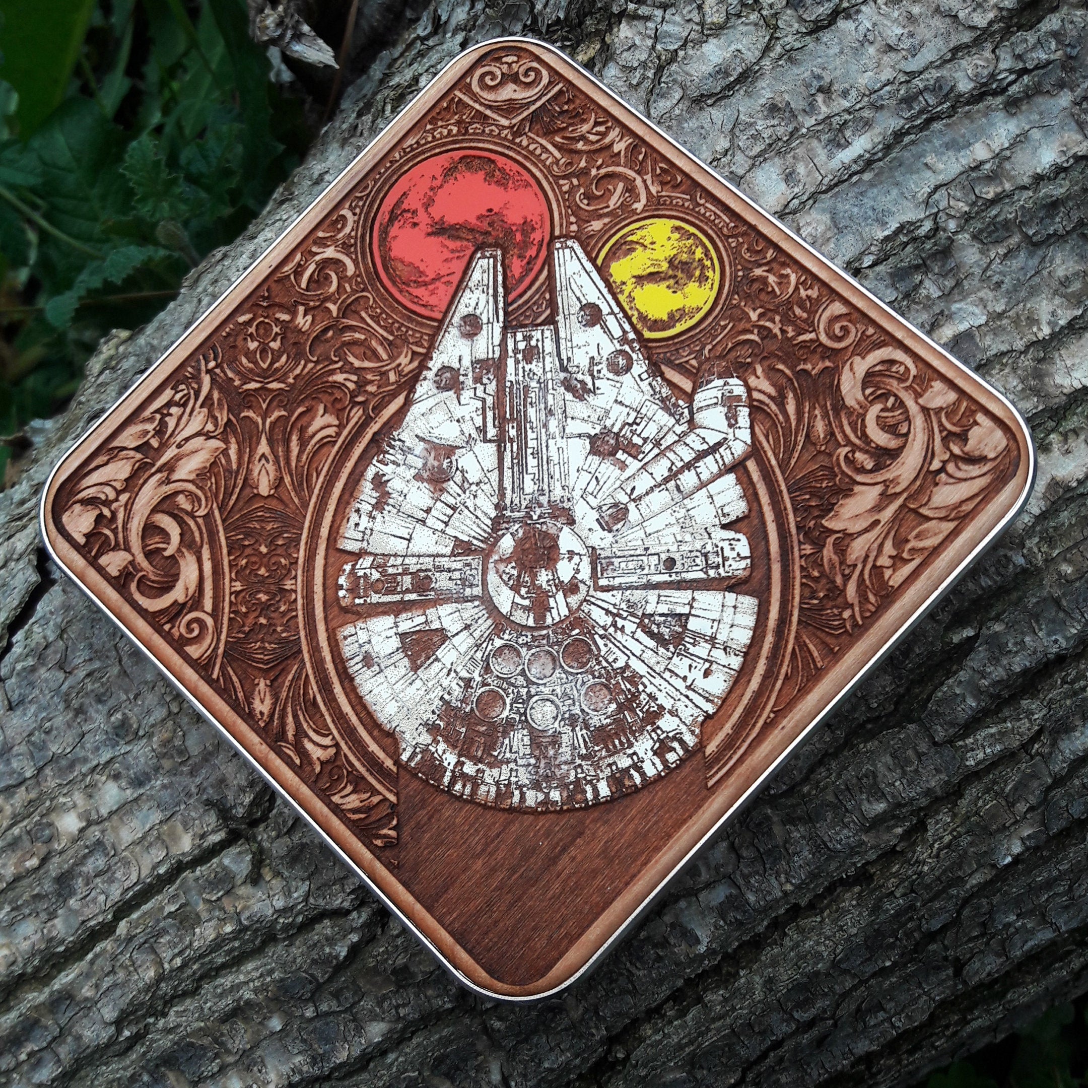 Overhead shot of engraved Star Wars-inspired ships on charging pad.