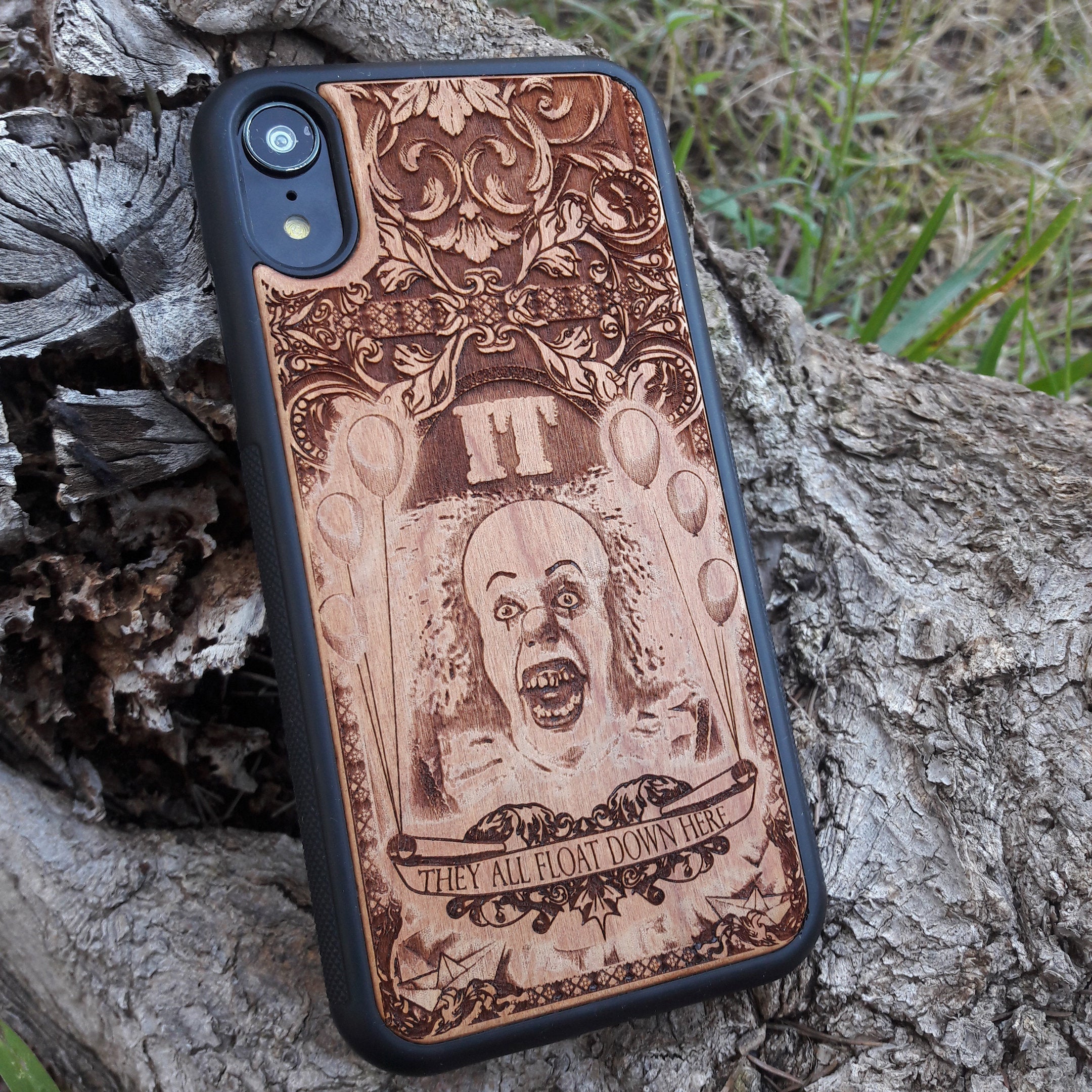 Wooden phone case with Stephen King's It clown design, intricately carved for iPhone , iPhone 15, Galaxy S, S24, Note 20, and more. Ideal for horror fans seeking unique protection and artistic style.