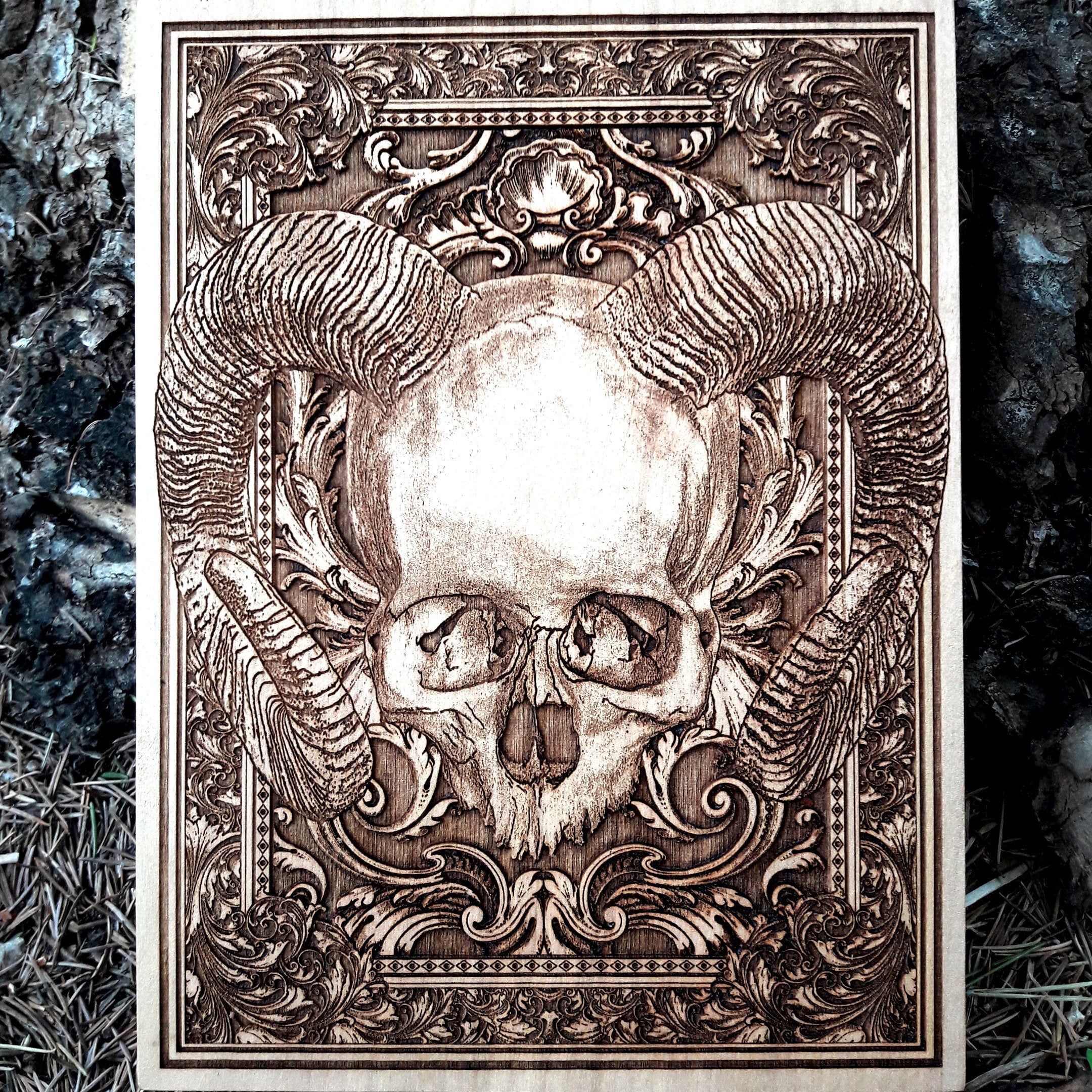 Handcrafted horned skull wood wall art, gothic and macabre decor, occult-inspired dark art engraving.