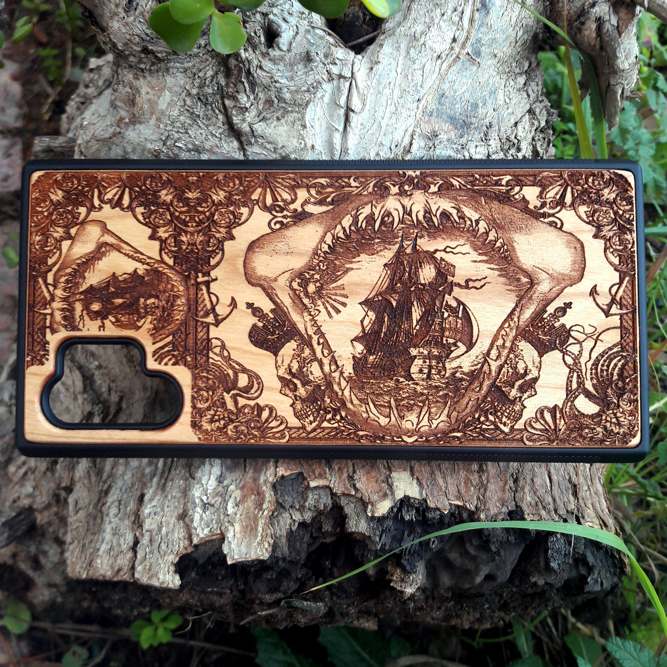 Wooden phone case with an intricate marine shark mandible design, featuring a detailed shipwreck and nautical elements. Laser-engraved on high-quality wood, this case is compatible with iPhone , iPhone 15, Samsung Galaxy S, S24, and more. Perfect for ocean lovers and those seeking a unique, eco-friendly accessory.